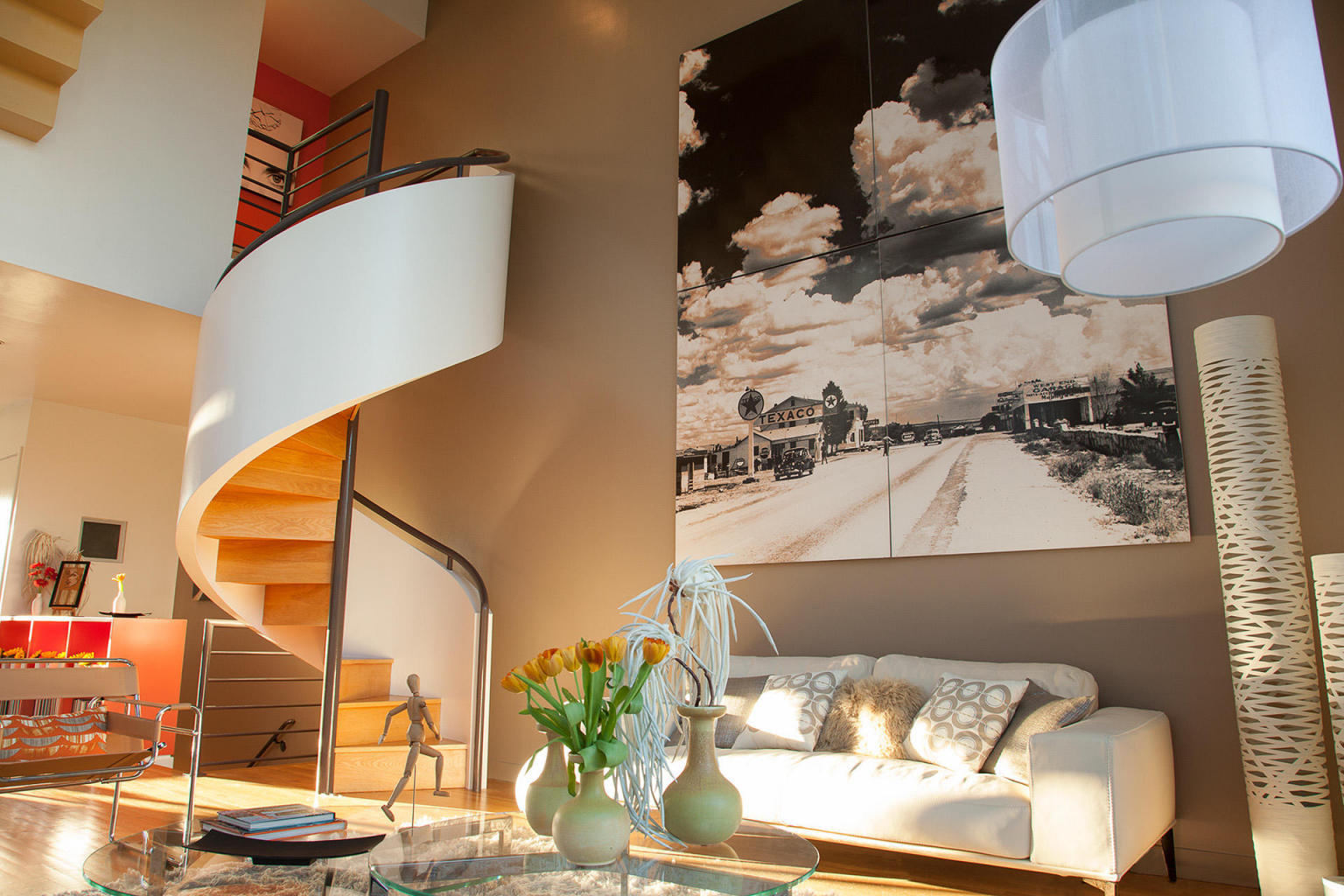 Stairway to Heaven is named for its unique rooftop spiral staircase that leads to the fascinating views of the gulf and the iconic community of Seaside. These panoramic views can also be enjoyed from the exquisitely designed rooftop terrace. This modern townhouse was designed by internationally recognized New York architect, Alexander Gorlin. Blending distinctive architectural styles and decorated with outstanding personality, 302 Ruskin Place is absolutely incomparable. The double-height glass windows in the living area allow for a spectacular view of Ruskin Place, a cohesive juxtaposition of the Live, Work, Play lifestyle concept. This polished home was featured in the 1996 movie 'The Truman Show', which is still remembered by a ''Rubeo Architects'' sign which hangs out front.