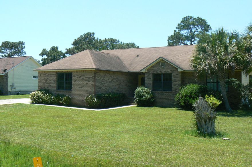 What a great price for a home in Holley By the Sea. This 3 bedroom 2 bath brick home with side entry double-car garage is ready for you. With over 1400 square feet of living space, the high ceilings in the fully-tiled living area creates an open atmosphere. The kitchen is spacious with granite countertops. Inside laundry room and good storage throughout home make this a comfortable place to live. You will also have full access to the Holley recreation center, and the location of this home on Sparrow Lane makes it fast and easy to get to the beach, exercise in the fitness facility, play tennis or swim. This home sits on a quiet street on almost a half acre of land. With today's interest rates, you easily can own instead of renting. Seller is even open to seller financing. Come and see!