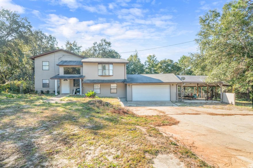 Take a look at this 3 story home with two living rooms, covered patio area, new flooring and paint, and double size lot on a quiet street just minutes from shopping and Navarre Beach! On the main floor is kitchen, dining, laundry, bedroom, and bathroom. Downstairs is a large family room with exit to garage. Upstairs is the main living room, master bedroom/bathroom, and additional bedroom. Seller is motivated!