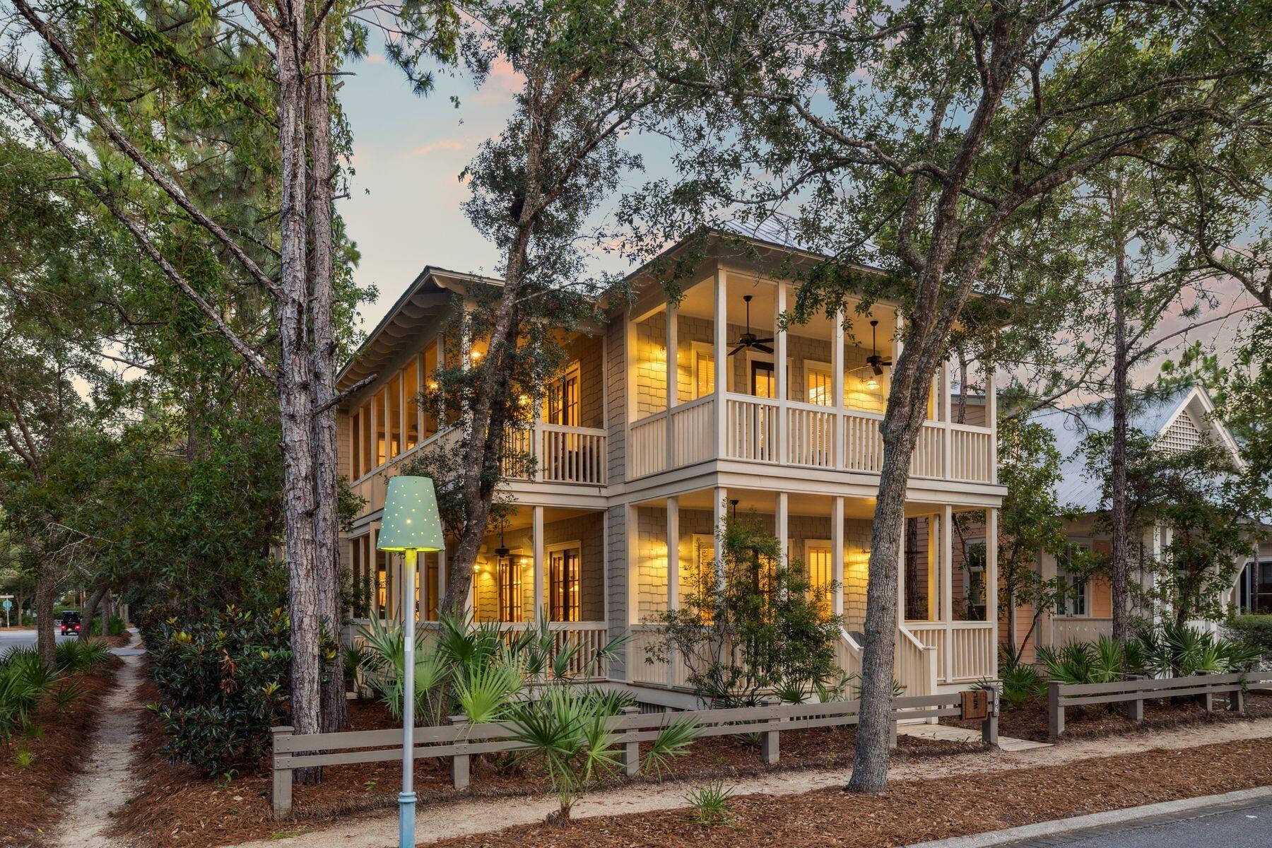 Tucked in the vibrant heart of WaterColor, this stunning 5 bedroom home is the epitome of laid-back luxury and timeless coastal charm. Set on a lushly landscaped corner adjacent to Camp Watercolor, it offers a rare sense of privacy in one of Watercolor's most sought after locations. With 5 bedrooms and 5 full baths including the carriage, the home offers flexibility for different groups. Enjoy three covered and screened porches complete with porch swings and rocking chairs. You'll love soaking in the breeze and embracing the resort-style living that makes WaterColor so special. Inside, the open-concept design blends the spacious kitchen and island with a welcoming dining and living area on either side. All flow seamlessly to a large screened porch, perfect for outdoor dining and family game nights. Each bedroom features its own ensuite bath, and the separate carriage house offers its own living space and bedroom suite. Beneath the carriage house are two covered parking spaces as well as a third uncovered space. From wide plank wood flooring and shiplap walls to custom tile baths and showers, every detail has been thoughtfully crafted. Whether you're looking for a full-time residence, an income-producing rental, or a vacation home next to one of Watercolor's best amenities, this property delivers the best of the Watercolor lifestyle.