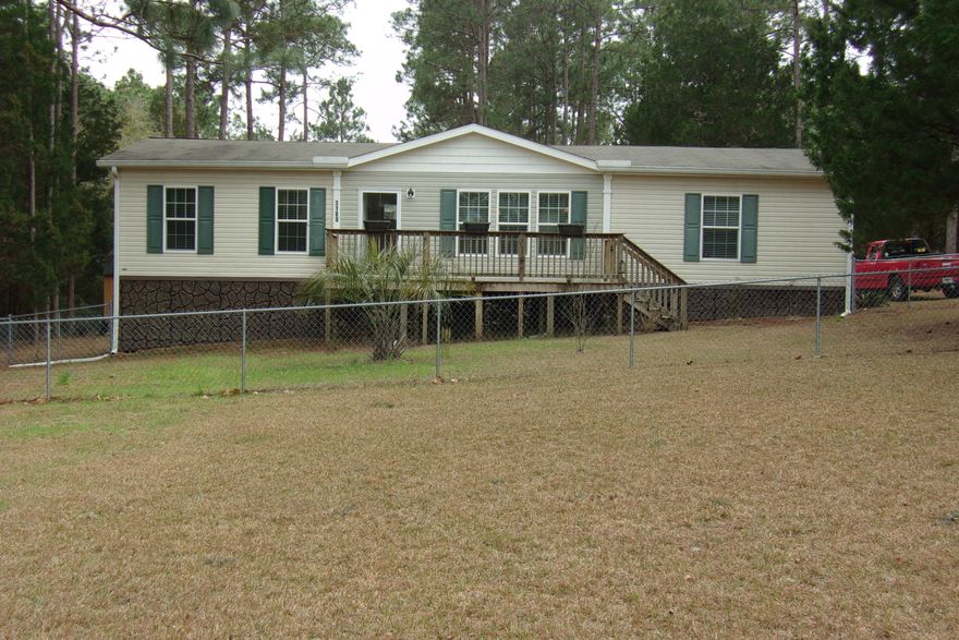 Immaculate 3 bedroom, 2 bath on 1 acre on paved road~  This home has been well maintained!  Fresh paint, new vinyl plank flooring in the kitchen, laundry, dining room, living room and foyer~  Friese carpet in the bedrooms~  Master bath has double vanity, large soaking tub, and separate shower~  Master bedroom has walk in closet~ Nice large deck on the back for enjoying the peace and cooking out~  Front yard has chain link fence and nice open porch ~  This home is move in ready~