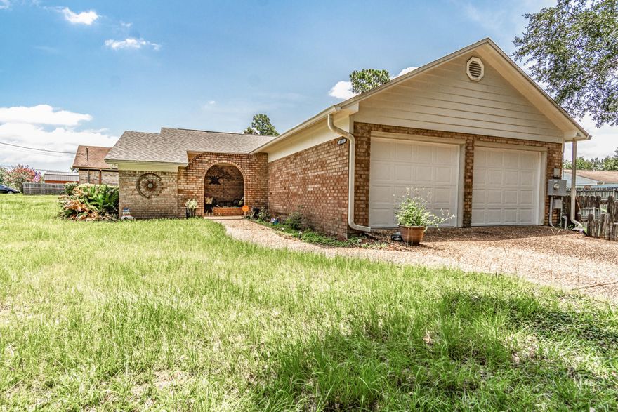 Home is calling! This Mediterranean style home features open living spaces with 3 bedrooms, 2 full baths, and it is all on a fenced 1/2 acre lot close to all that Pensacola has to offer. One of the bedrooms could be easily used as an office or a den space. The natural wood burning fire place is great for cozy nights. The front entry way and breezeway to yard and garage make this home one of a kind. You can enjoy this space in private while enjoying the outdoors. The large back yard is completely fenced, and there are two beautiful legacy oak trees shading the front. The 2 car garage offers max parking and storage while the pull down stairs allow for additional space in the attic. There is a central vacuum that will make any cleaning task quick and easy. Home Is being sold AS IS.