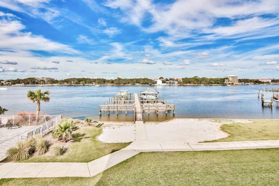 Gorgeous modern, FULLY FURNISHED sound-side townhome boasts its own boat slip, garage, and upscale finishes. Located within walking distance to the beautiful white sand beaches of the Emerald Coast, and a short boat ride away from the world famous crab island. Each residence includes a 28' by 12' boat slip, lofted 14' ceilings in the living area, high impact windows/doors and metal roof. This fully equipped Chef's kitchen includes a Wolf Induction stove top and Wolf oven, granite counter tops, and stainless steel appliances. Additional amenities include a private community pool with sun deck, private two-car garage, and private dog park.Whether you are looking for a primary residence, second home, or rental property, this unit is the perfect place for you!