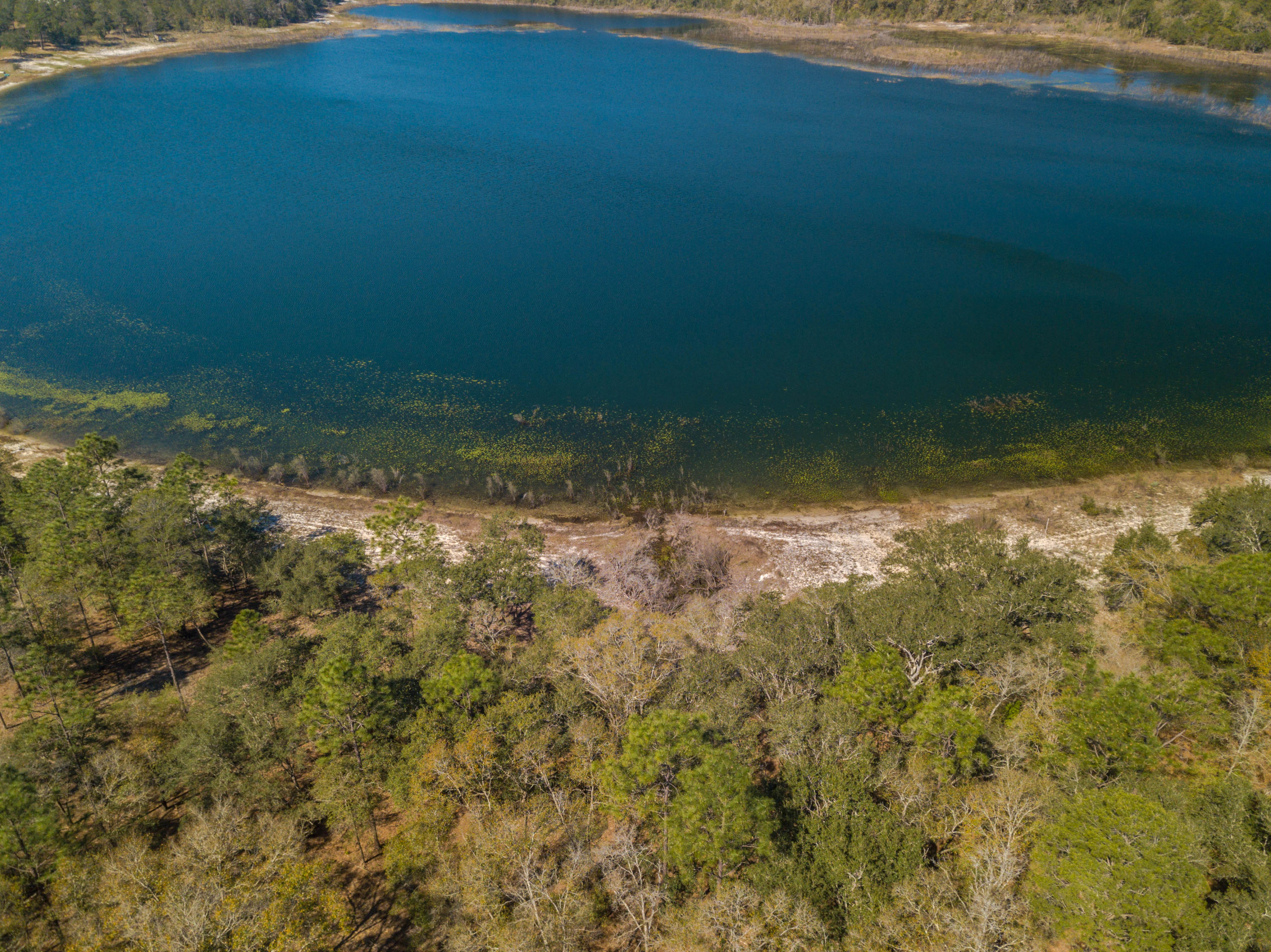 Build your dream home or have a vacation home on this beautiful spring fed lake. Water will always be clear and cool - as it should be in paradise! The lot has been somewhat cleared so you can see the water. The adjoining parcel is also for sale for $35,000. Buy both and enjoy a package discount of $5,000, for a total price of $80,000. Ask your Realtor for a list of the rules and regulations but there is no HOA. Current zoning allows for a home and outbuilding as long as the outbuilding is not a residence. Please drive by and call your Realtor if you'd like to make an offer!