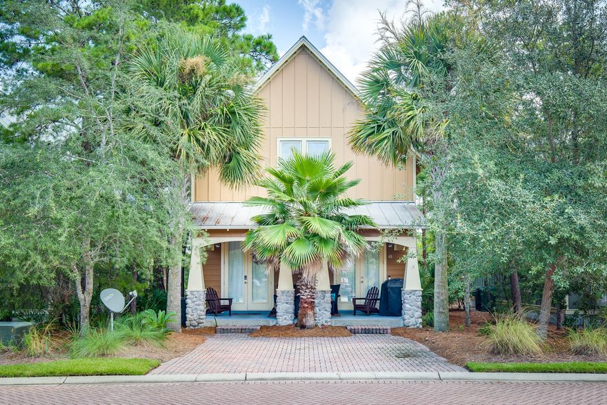 Feel instantly at home at this cozy beachside retreat with the perfect combination of style and function. Located in the Cottages at Santa Rosa Beach, this Craftsman-style 3BR/3.5 BA is just steps from the Ed Walline public beach access, Gulf Place Town Center with dining, shopping, and events, and the popular Shunk Gulley restaurant. A covered front porch with stone columns welcomes you into a bright and cheerful living space with beautiful hardwood floors and wainscot wall paneling. The fully equipped kitchen offers granite countertops, fun two-toned cabinetry, stainless steel appliances, tile backsplash, and a breakfast bar with seating for four adjacent to the light filled dining area.