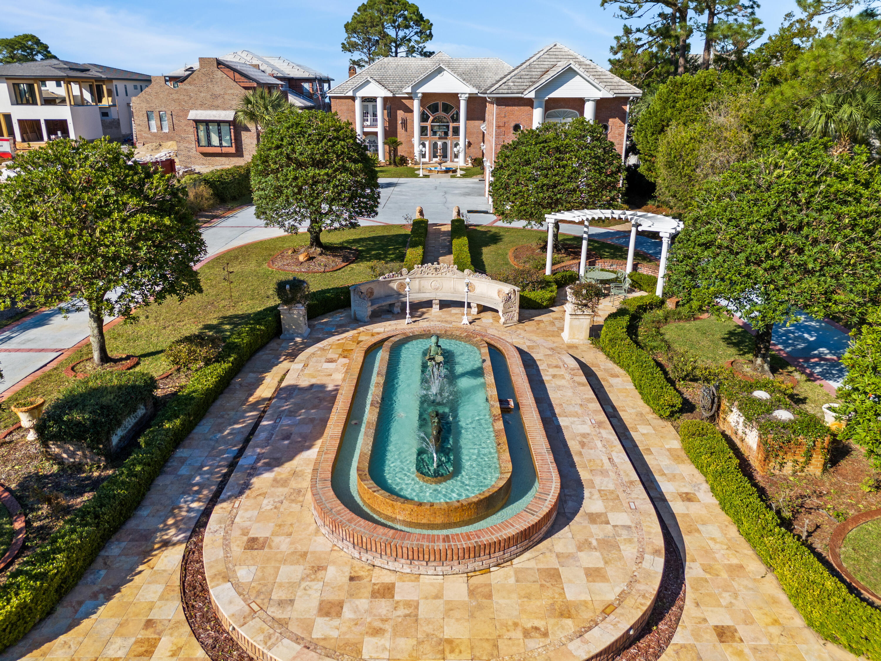 ***OWNER FINANCING OFFERED: 40% TO 50% DOWN, 6.5% FIXED RATE, 30 YEAR AMORTIZATION, 5 YEAR BALLOON*** Hundreds of thousands of dollars in antiques and upgrades were carefully sourced from Antique Auctions hosted by ''The Great Gatsby'' in Atlanta and antique dealers from around the world. This 5 bedroom, 7 bathroom 8400+ square foot bay front villa estate(with a separate fully functional guest home)has so many luxurious finishes it's impossible to list them all...but I'll do my best!! Pontoon boat has less than 15 hours of use and comes with the sale! Upon entering this gated estate you are greeted with immaculate grounds, gardens, and courtyards with breathtaking mosaic fountains, marble statues, hand painted pottery, a marble gazebo, and beautiful marble benches. Columns greet you as you walk up to the home, and once inside you are greeted by 2 exquisite curved staircases, each accented by hand carved wood and under the grandest coffered ceiling with stained glass and Italian marble floors you have EVER seen. The ground floor master suite leaves nothing to be desired with a sitting area that features floor to ceiling glass to take in the breathtaking bay views. The master bath features include a jetted soaking tub, steam shower, oversized vanity, all encompassed in imported hand chosen marble. The formal living room features a grand piano and gas fireplace and leads into the chef's kitchen that offers an oversized island, custom cabinetry, and a fireplace that could easily be converted into a pizza oven! Adjacent to the kitchen is an additional sunlit interior full bar and summer kitchen with a high end grilling area(and original Wyland glass built in picture window valued at $10,000) that looks out into the enclosed heated atrium style pool and hot tub that were built into a covered brick alcove with arches, a bridge, jacuzzi and balconies, all overlooking the bay. The second floor offers 2 oversized bedroom suites with their own en-suite bathrooms, as well as a billiards room and den with a bar imported from England that rivals any exclusive private membership club. The coffered ceilings and woodwork rival any European castle or estate. A spiral staircase leads to a serene third floor sitting room perfect to get away from it all, with more breathtaking views of the bay for you to enjoy either inside or from the private balcony. Above the 4 car climate controlled garage you find the oversized guest cottage that offers a large living area/bedroom, additional bedroom with tongue and groove cathedral ceilings, a small kitchen, dedicated pantry, and 2 full bathrooms. Most of the windows in the home have been replaced in the last 2 years. Stepping out into the backyard of this incredible estate you will find intricate landscaping, marble gazebos, swings, a koy pond, and landscape lighting all leading to 107 feet of seawall protected waterfront. The private dock includes a covered boat lift, 2 jet ski lifts, canoe launch, and a second story rooftop sundeck that is guaranteed to provide stunning bay views and breathtaking sunsets. In total you have 7 fountains, 8 A/C units(2 are newer) and the most marble and detailed crown molding that you will ever see in a home of this size. With too many features to list, this estate/villa has it all and needs to be seen to be truly appreciated. All furniture is negotiable. All information is approximate and should be verified by buyers if important.