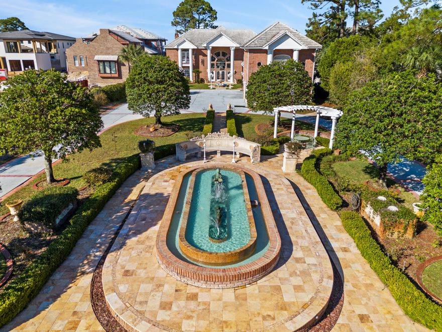 ***OWNER FINANCING OFFERED: 40% TO 50% DOWN, 6.5% FIXED RATE, 30 YEAR AMORTIZATION, 5 YEAR BALLOON*** Hundreds of thousands of dollars in antiques and upgrades were carefully sourced from Antique Auctions hosted by ''The Great Gatsby'' in Atlanta and antique dealers from around the world. This 5 bedroom, 7 bathroom 8400+ square foot bay front villa estate(with a separate fully functional guest home)has so many luxurious finishes it's impossible to list them all...but I'll do my best!! Pontoon boat has less than 15 hours of use and comes with the sale!  Upon entering this gated estate you are greeted with immaculate grounds, gardens, and courtyards with breathtaking mosaic fountains, marble statues, hand painted pottery, a marble gazebo, and beautiful marble benches. Columns greet you as you walk up to the home, and once inside you are greeted by 2 exquisite curved staircases, each accented by hand carved wood and under the grandest coffered ceiling with stained glass and Italian marble floors you have EVER seen. The ground floor master suite leaves nothing to be desired with a sitting area that features floor to ceiling glass to take in the breathtaking bay views. The master bath features include a jetted soaking tub, steam shower, oversized vanity, all encompassed in imported hand chosen marble. The formal living room features a grand piano and gas fireplace and leads into the chef's kitchen that offers an oversized island, custom cabinetry, and a fireplace that could easily be converted into a pizza oven! Adjacent to the kitchen is an additional sunlit interior full bar and summer kitchen with a high end grilling area(and original Wyland glass built in picture window valued at $10,000) that looks out into the enclosed heated atrium style pool and hot tub that were built into a covered brick alcove with arches, a bridge, jacuzzi and balconies, all overlooking the bay. The second floor offers 2 oversized bedroom suites with their own en-suite bathrooms, as well as a billiards room and den with a bar imported from England that rivals any exclusive private membership club. The coffered ceilings and woodwork rival any European castle or estate. A spiral staircase leads to a serene third floor sitting room perfect to get away from it all, with more breathtaking views of the bay for you to enjoy either inside or from the private balcony. Above the 4 car climate controlled garage you find the oversized guest cottage that offers a large living area/bedroom, additional bedroom with tongue and groove cathedral ceilings, a small kitchen, dedicated pantry, and 2 full bathrooms. Most of the windows in the home have been replaced in the last 2 years. Stepping out into the backyard of this incredible estate you will find intricate landscaping, marble gazebos, swings, a koy pond, and landscape lighting all leading to 107 feet of seawall protected waterfront. The private dock includes a covered boat lift, 2 jet ski lifts, canoe launch, and a second story rooftop sundeck that is guaranteed to provide stunning bay views and breathtaking sunsets. In total you have 7 fountains, 8 A/C units(2 are newer) and the most marble and detailed crown molding that you will ever see in a home of this size. With too many features to list, this estate/villa has it all and needs to be seen to be truly appreciated. All furniture is negotiable. All information is approximate and should be verified by buyers if important.