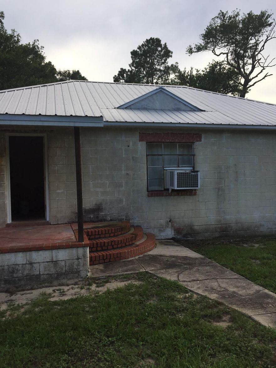 Calling all investors! Come check out this 2 bedroom / 1 bath house with a new metal roof and a basement in Defuniak Springs. Needs TLC but has tons of potential and sits on close to a half acre corner lot.