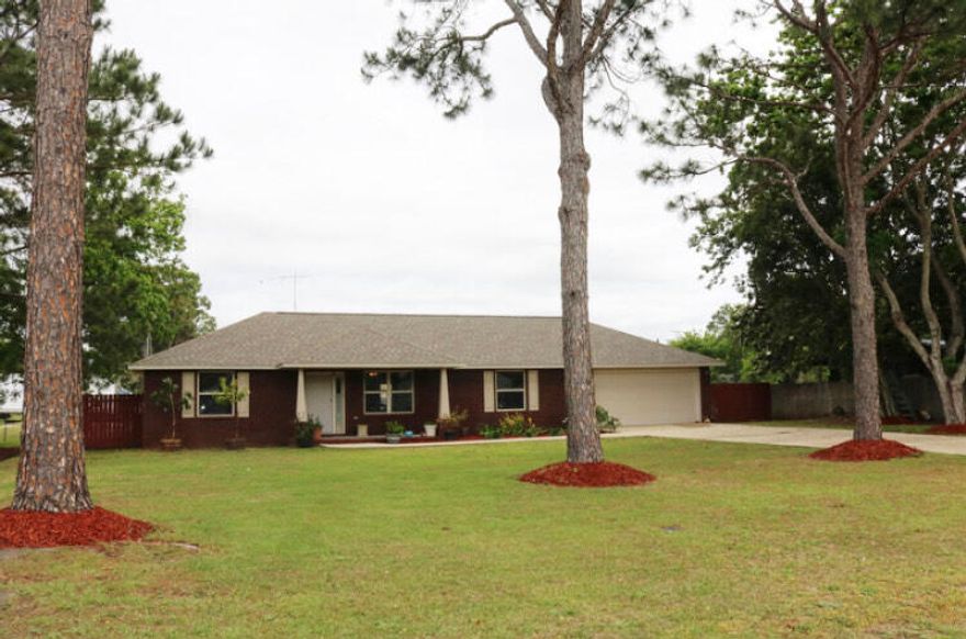 This home has a great open floor plan, den and dining area combined . Brand new hardy plank flooring, wet areas all tile. Newly painted in most areas, Kitchen has stainless steel appliances ,breakfast bar area, updated cabinets with lots of counter space and cabinets. Master has double vanity's , walk in closet and garden tub/shower .Extra room 19x 11.5 can be used as an office/den/home gym etc. Tilt and slide windows throughout, garage is slightly oversized and has an entry way to the back yard. Relax on the newly painted 16x 12 wooden deck and wash the day away. Home  also comes with an AS IS workshop /yard building 25/20 with electric hook ups. Home also has a monitored alarm system.