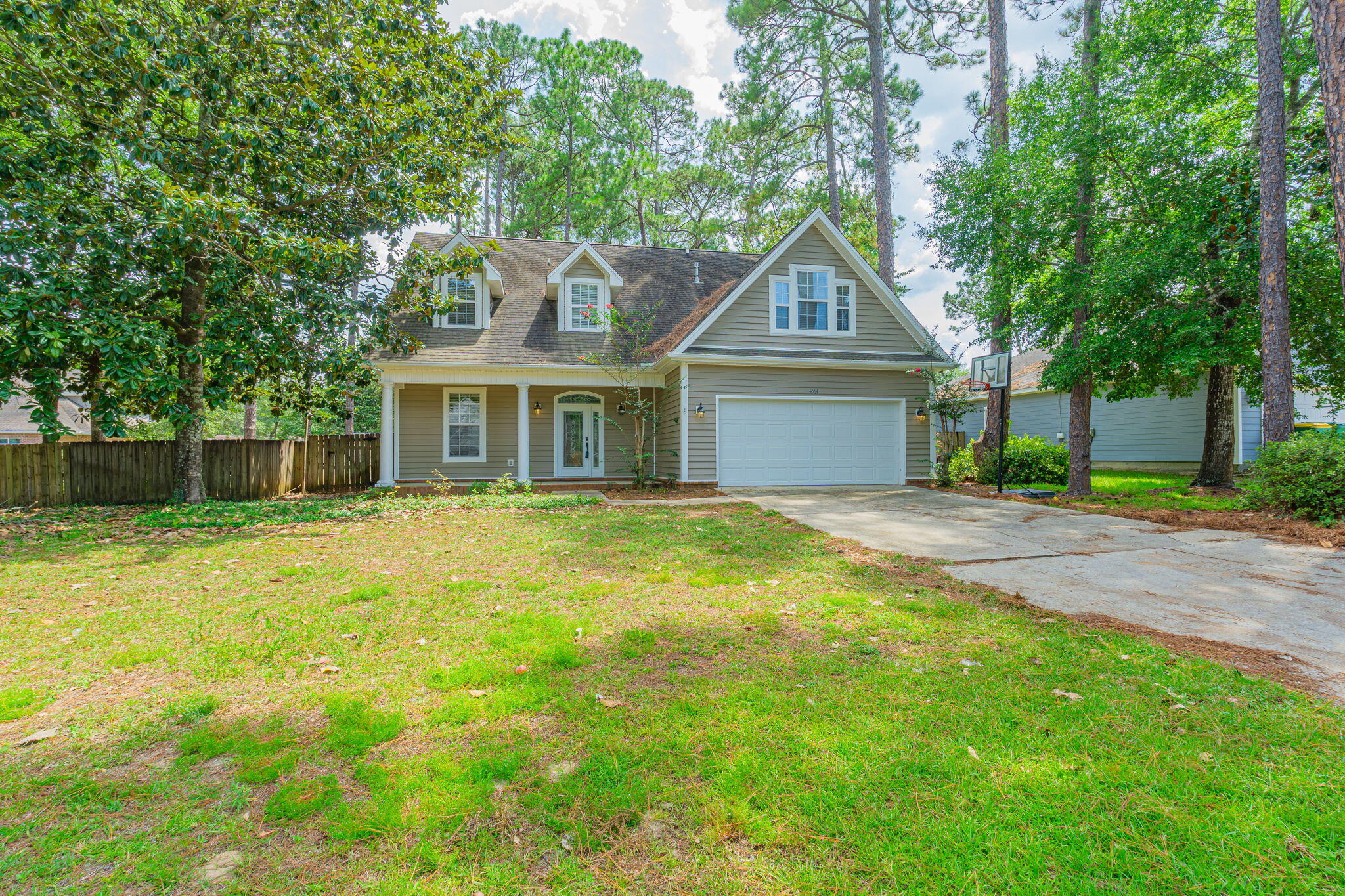 This stunning home features cedar ceilings, vaulted spaces, and real hardwood floors in the foyer. With 4 spacious bedrooms and 2.5 bathrooms, there's room for everyone and each bedroom includes at least one walk-in closet for ample storage. One upstairs bedroom even has a secret play area built under the eaves, perfect for imaginative kids or pets. Enjoy the comfort of built-ins and many custom touches that make this home truly one-of-a-kind. The fully fenced backyard is an entertainer's dream with a large, screened patio, ideal for year-round outdoor living. Located just 2 blocks from water access where you can launch your kayak or paddle board. Added bonus it is central to shopping, restaurants, and schools. This home blends convenience with charm and location. (buyer confirm measures)