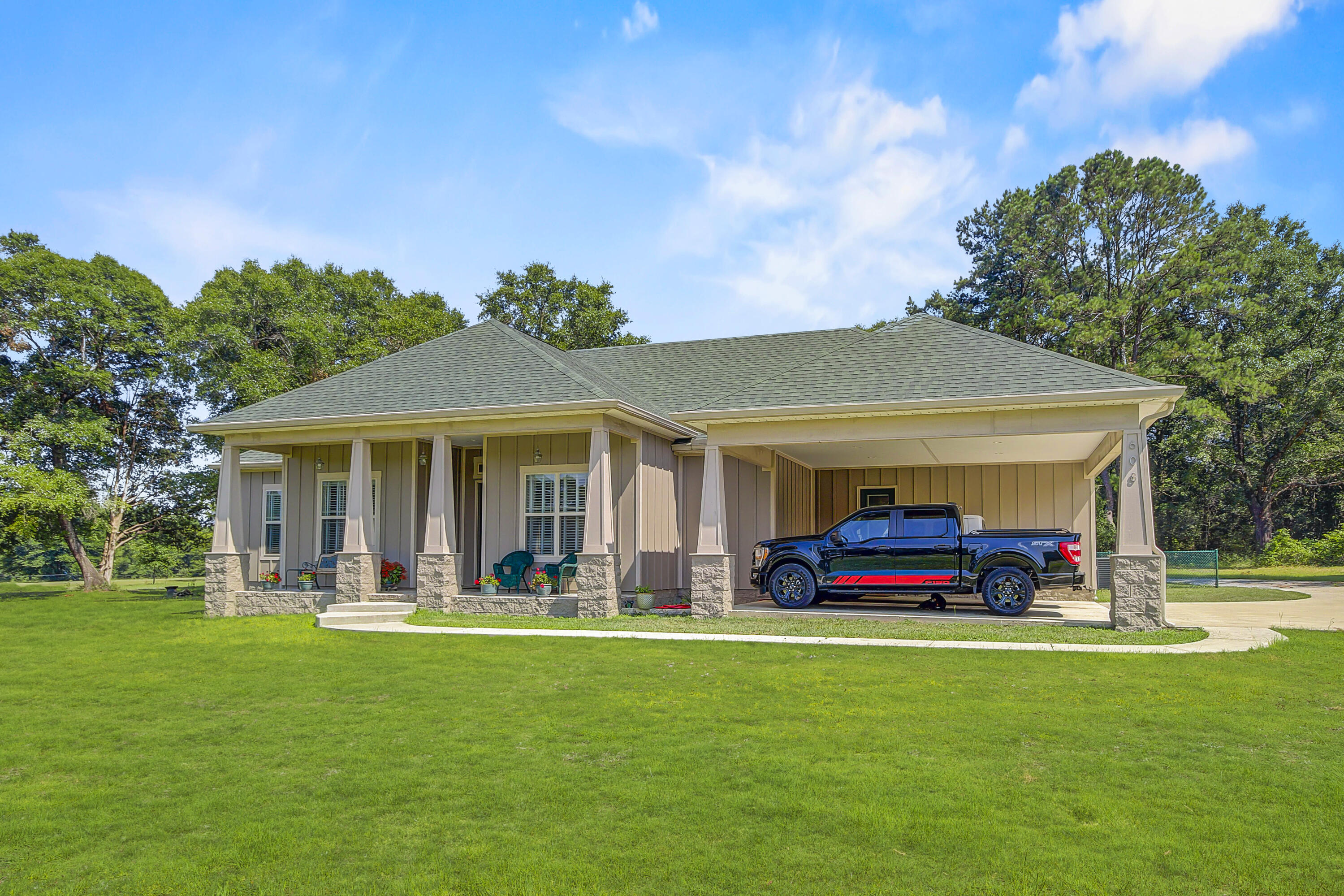 Custom home located on over 10 acres of cleared and fenced property. This 'like new' 3 bdr/3bath w/office home offers: LVP flooring throughout,10' ceilings, w/tongue and groove in liv rm ceiling, trey ceilings, gas fireplace, cooktop and tankless water heater, a large kitchen w/custom cabinetry/quartz countertops/island/breakfast bar and nook. Hardiplank w/brick exterior, seamless gutters w/leafguards, oversized carport, front porch invites you inside and screened back porch opens onto a deck overlooking the fenced in yard, gazebo w/whirlpool hot tub. A shed houses the well and provides storage, the asphalt driveway extends to the metal storage bldg/workshop w/concrete floor for storing all types of outdoor equipment. This property has been well maintained and is easy to use and enjoy