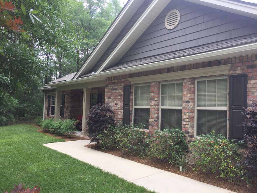 COUNTRY FEEL - CLOSE BY!!! Just minutes from town and close enough to bases to be so worth the drive! From the minute you walk in you know this is the place you want to stay! Open split floor plan, offers details only found in the finest of homes large foyer, large office/bedroom, powder room, jack & Jill bathroom. Dining room, great room and kitchen are open & Inviting. Kitchen has granite counters w/ breakfast bar, large pantry & tile flooring. Grand Master suite with sitting area w/built in book shelf, his & her walk in closets, master bath with separate shower & tub. Come out to the back deck and beautiful yard. One acre of gorgeous landscaping and natural areas as well. Can you mix country and executive living? Its been done beautifully here! Call to see today!