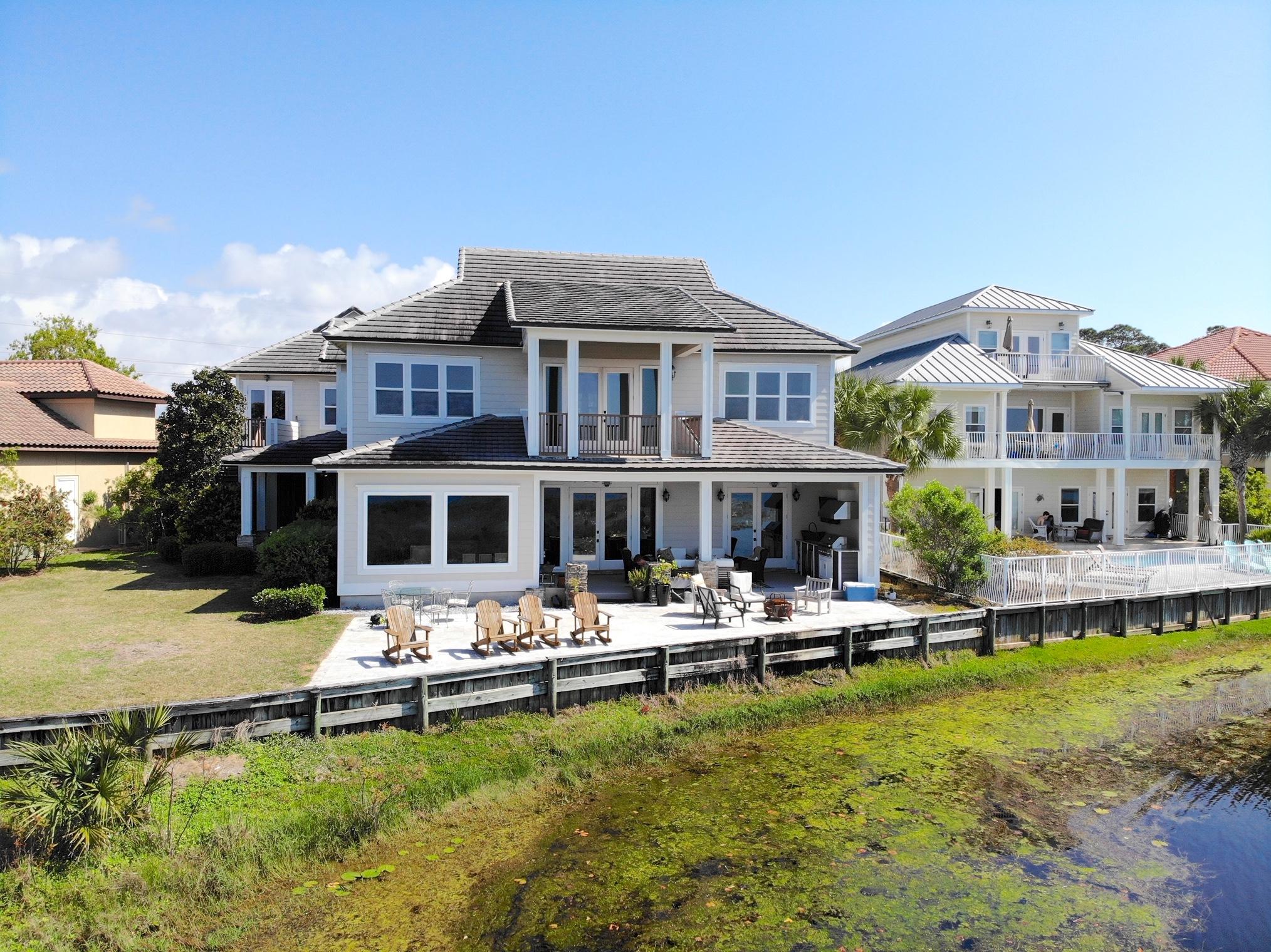 This custom built lakefront home with Guest house and gulf views has 7br, 5 1/2 baths, two full kitchens, three laundry areas, and is located in the exclusive gated community of Destiny East. Double sized lot with 110 of lake frontage provides privacy. The main house consists of 5 br's & 3.5 baths with a separate 1000 square foot guest house with 2br & 2baths and private entrance.. The house was designed to capture lake views from almost every room with expansive outdoor living space and room for a large pool. Recent upgrades include; two new 3 ton a/c, exterior and interior painted,, new carpet in bedrooms, new flooring, brand new porch/decking with outdoor kitchen, new renai hot water heater, new appliances, new lighting, and more. Gross rental projections exceed 160k !