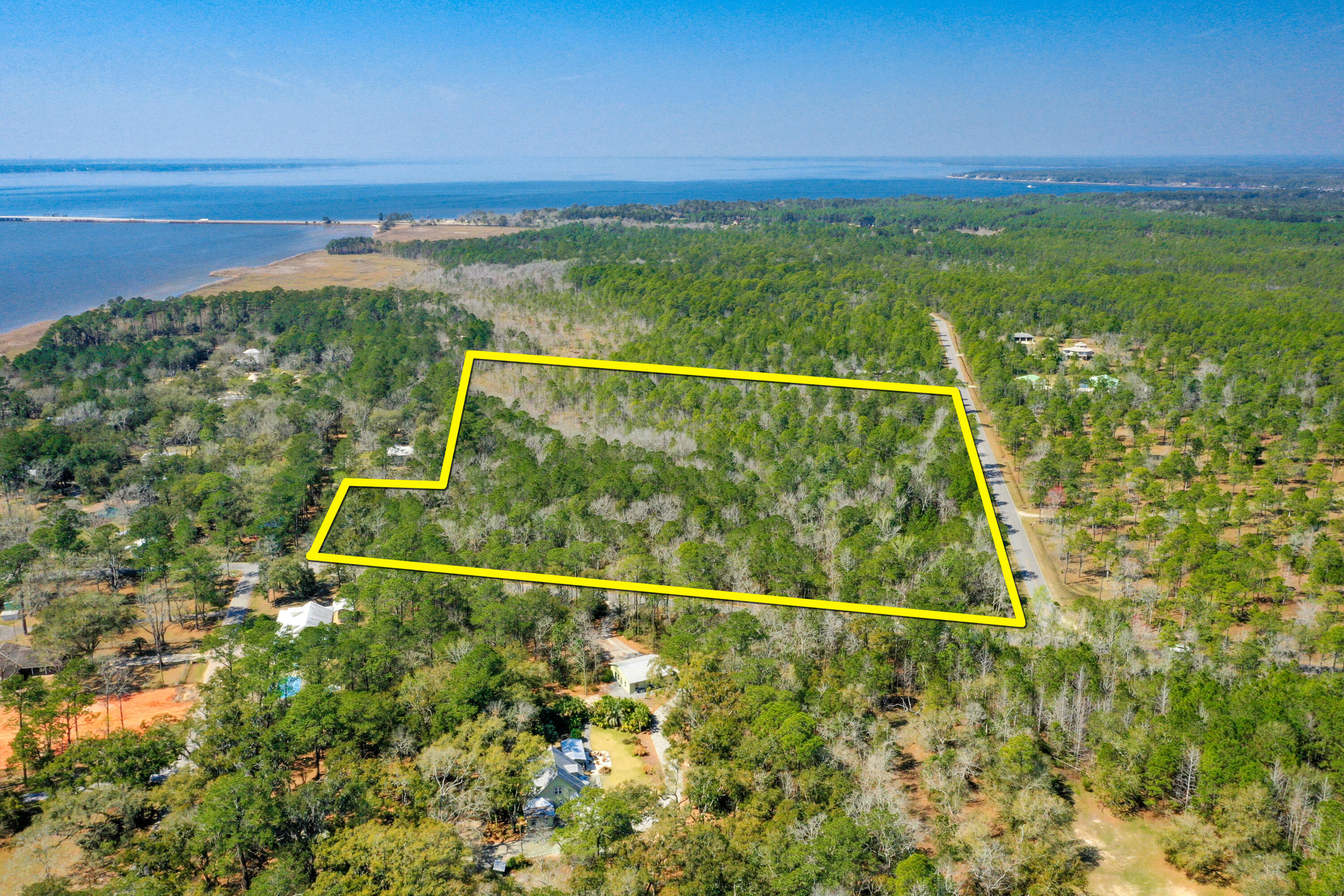 Just Listed! (7) contiguous prime parcels totaling approximately 12-acres located across from the Choctawhatchee Bay and oriented between two street corners at Jolly Bay Road and Fluffy Landing Road. This assemblage offers convenient access from Highway 98 in South Walton County, as it easily accessible via paved County maintained road at the new traffic light at Jolly Bay Road and the newly expanded bridge and Highway 331; thus, allowing for a multitude of residential uses only minutes away from the gorgeous beaches of South Walton County in Santa Rosa Beach, Florida. (3) of the (7) contiguous parcels are located within a community known as Jolly Bay Acres, which not only offers a quaint picnic area and park setting on the shoreline of the scenic Choctawhatchee Bay, but also will... allow the future owner(s) the use of (3) assigned boat slips. The Walton County zoning (aka future land use) is known as Rural Residential. This opportunity would permit a host of viable and marketable residential site planning scenarios, perhaps including, but not limited to the larger acreage being developed as a private neighborhood, while the (3) single-family platted lots yield individual new houses; or the druthers of the buyer may be to enjoy this gorgeous expanse of native old Florida property as a private family compound in a very tranquil, serene setting along the flourishing Emerald Coast of Florida. Please inquire for further details.