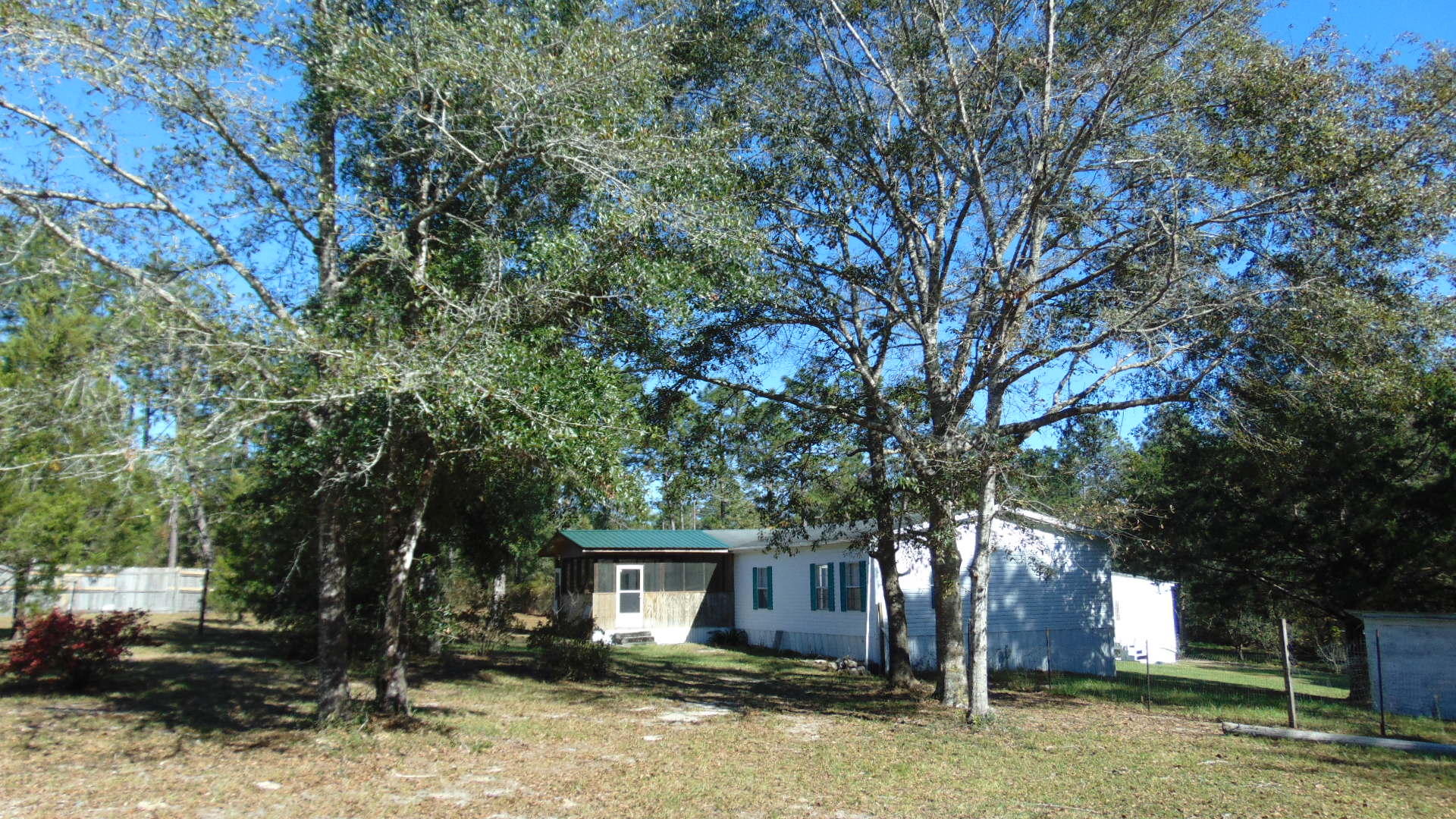 Private Ranchette with 6 fenced acres! Enjoy country living with the convenience of being close to shopping and less than 4 miles from I-10. The spacious master bedroom has a sitting room/office and master bath with garden tub, shower, double vanity, and walk-in closet. 4th bedroom was converted into a separate dining room but could be made back into a bedroom. The kitchen has a roomy island/breakfast bar and large walk-in pantry. Laundry room is conveniently located off of the kitchen with door to the deck. Overlook your gorgeous property off of the large deck on the back of the home. Property has Apple, pear, and fig trees too.  Bring your horses and animals to complete your country ranchette! Welcome home.