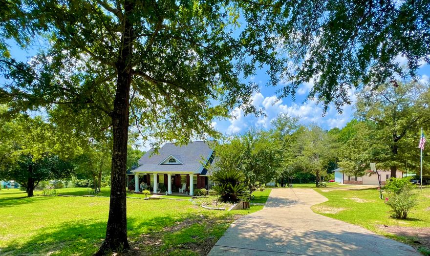 PRICE IMPROVEMENT AND NEWLY POURED REAR PATIO!! Pour yourself a glass of wine, relax and unwind on your new rear patio! Southern Living Charm is what you will find in this mini estate of 5 sprawling acres in Laurel Hill. A true classic beauty, this 4 bd/2 ba home features a large columned front porch complete w/ tiled flooring and windows adorned w/ dentiled white trim pediments. As you enter the home, you are greeted by vaulted ceilings and the total WOW factor. Spacious living room features a cathedral ceiling and wood burning stone fireplace w/ beautiful mantle piece. The kitchen boasts solid oak cabinetry, stainless steel appliances and adjacent dining area w/ large windows providing natural light. The master suite features dual vanities, garden tub, separate shower and dual closets