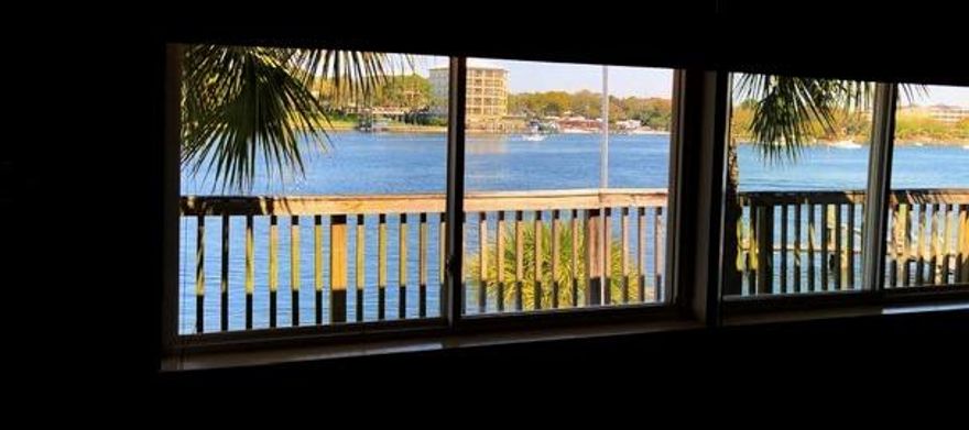 THIS IS IT!!! #BOATLIFE #BEACHLIFE PRIME waterfront location with assigned deep water boat slip, beach area and deck to view the fireworks and more!!! This waterfront AND waterview unit sits on the Intercoastal Waterway & allows incredible views from the living room, kitchen, bedroom and deck! The kitchen and living room are one large open space. Neutral tile floors throughout make this condo easy to maintain. Your ''backyard'' includes a sandy beach w picnic tables, fish cleaning station, boat launch and dock w assigned slip. Plus you are only steps away (.2) from the county gulf side beach access. On site laundry is available or you can install a stackable in one of the unit's storage closets. No worries here with concrete block and brick construction and 15 ft above sea level!