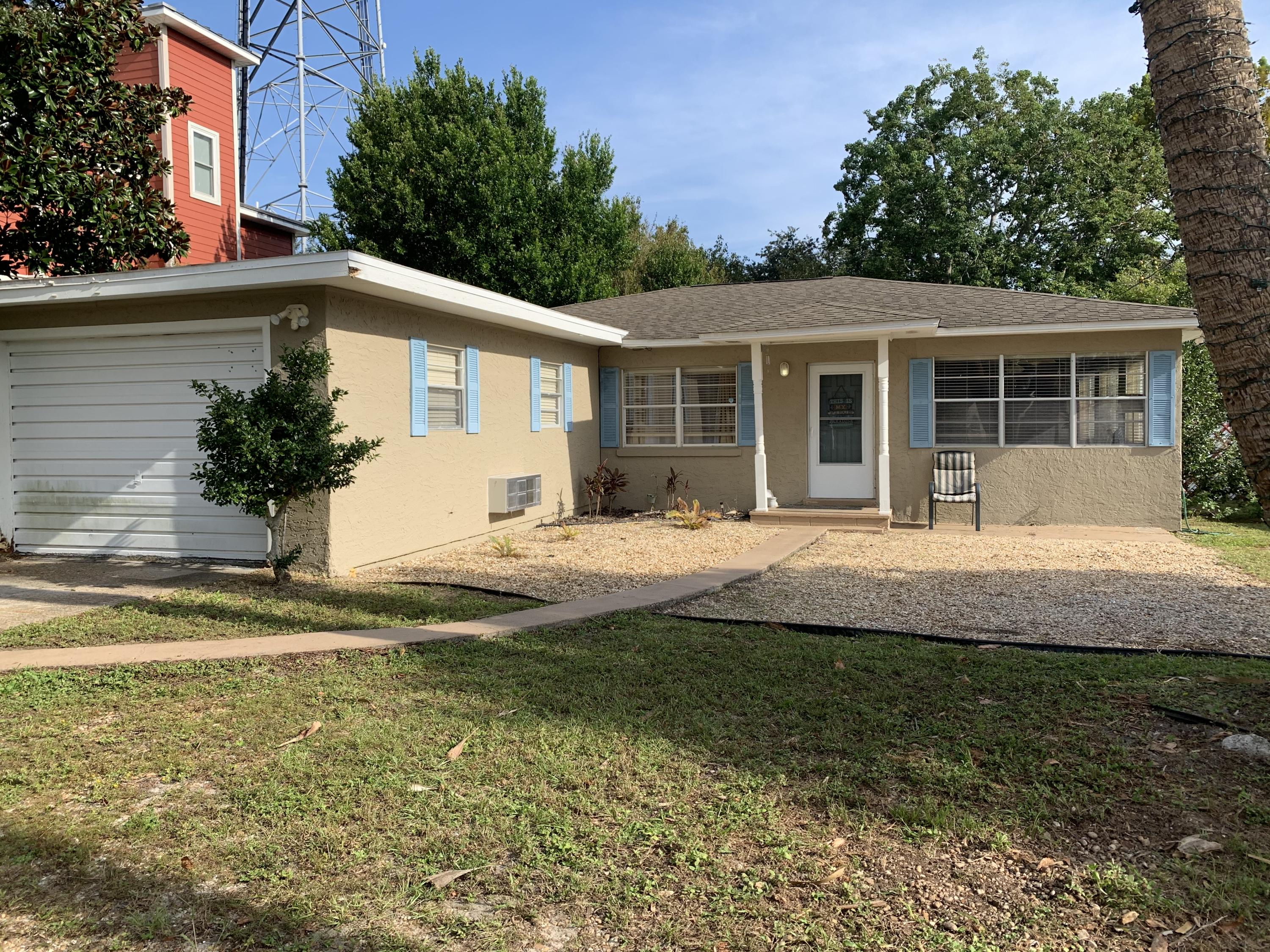 Investor opportunity in Panama City Beach. This wonderful ranch-style home is located 5 blocks from the sand and waters of the Gulf of Mexico. Enter the home to find an over-sized living/dining room combination, along with two full bedrooms and full bath on the hallway. The third bedroom is within the enclosed garage with a full bath and has a separate entry way - perfect for a mother-in-law suite, lockout unit or a home office. The best use is to rent out this side for an income producing property. The living room includes a bonus room that can also double as a family room. The yard is spacious, over .15 acres, has a large orange tree, and fenced on all sides for extra privacy. Not to mention, you're a golf cart ride to Pier Park, Frank Brown Park or your favorite restaurant here in PCB!