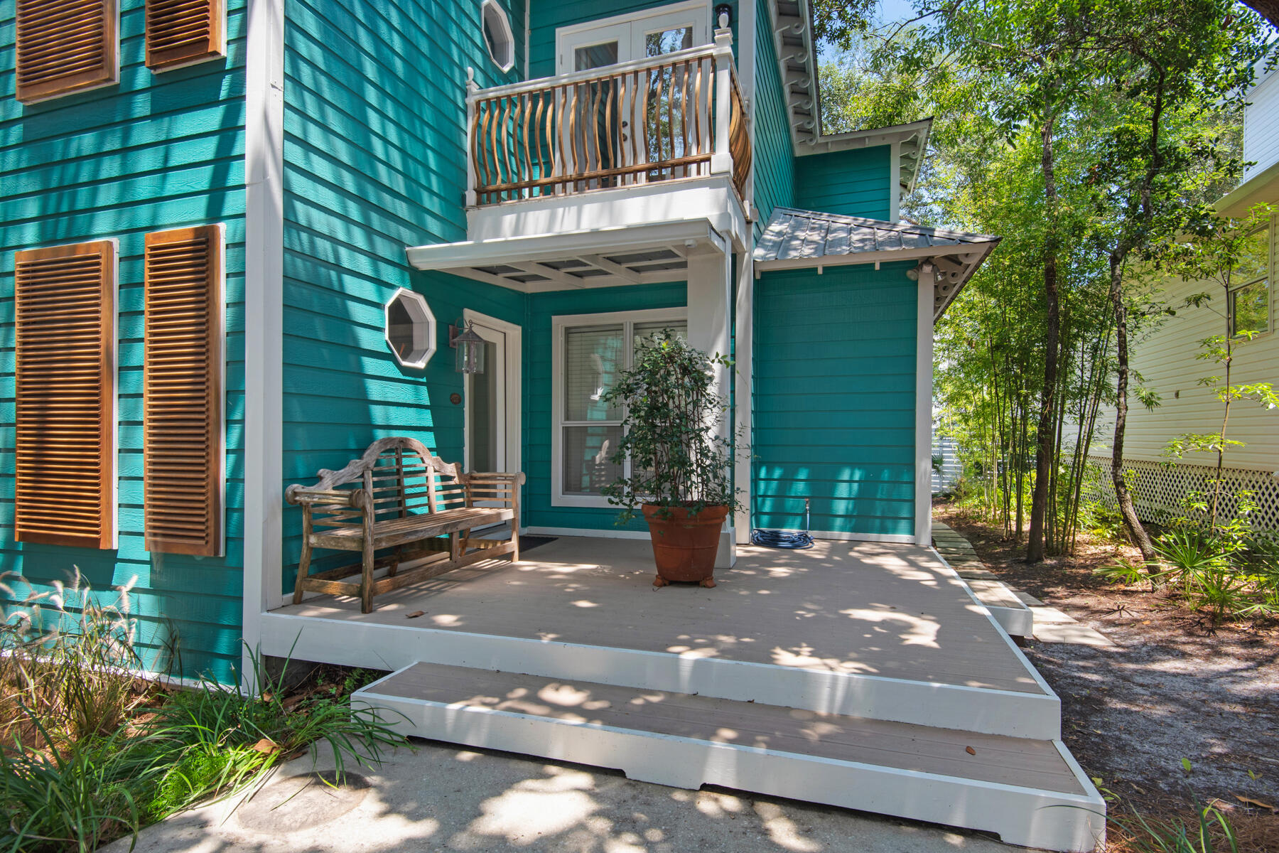 Tucked away on a quiet cul-de-sac one block from the beach, beneath a canopy of mature oaks & magnolias, this desirable beach house is in pristine condition. Built in 1994, it has only had two owners, fastidiously maintained and never rented. DEEDED BEACH ACCESS shared by a small number of houses, gives owners access to a stunning private beach with front row water views and private chair/umbrella rentals. Spread over three floors, this home has a first-floor primary suite, two large additional bedrooms with ensuite bath, a guest bath off living space, open concept living dining with gas fireplace, and a well-appointed kitchen. There is room for a pool, renderings pictured for ideas. There's also a versatile 28-ft. bonus room on the third floor, lined with windows and flooded with natural light. It's an ideal office, hobby studio, extra bedroom for guests or build out to a full 4th bedroom with small bath. A series of patios, screened porches and decks on all levels provide an abundance of quiet retreats and social spaces for outdoor living. They have all been regularly maintained with new flashing, new decking and new paint, when required. Large tile and hardwood flooring indoors add to the upscale ambiance of a home that's clearly designed for comfortable living. The second- and third-floor rooms have private balconies and there's a large, screened porch off the kitchen with a pass-through window for easily serving cocktails and alfresco dining, plus an outdoor shower for a quick rinse after the beach. Stainless steel appliances and a laundry closet with a new LG washer-dryer complete the kitchen facilities. Other features to note include deeded beach access, no rental restrictions and room for a pool on the 0.12-acre lot. New HVAC and ground level duct 2024. The home is filled with high-end furniture which can transact with the purchase.