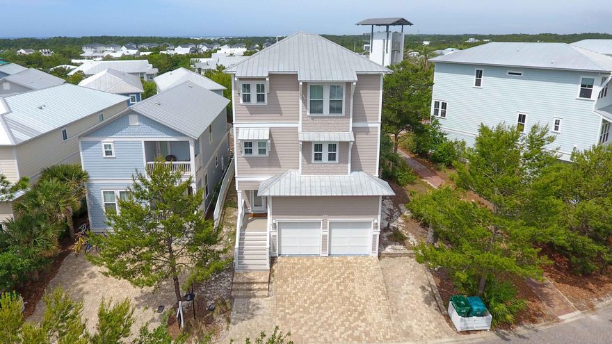 LUXURY Living! This extraordinary 4-bed, 3.5-bath, three-story home offers coastal living at its finest. The main floor features a flexible living space/bunk room duo and a prepped elevator shaft for added convenience. Furnished with over $100K in high-end Arhaus pieces, it's the perfect blend of style and comfort. Enjoy a 2-car garage plus 3 extra parking spaces, a covered patio with foosball and a gas grill, and a newly added paver patio for al fresco dining. A 6-seater golf cart makes exploring 30A effortless. The master suite features a fireplace, office nook, and stunning Gulf views. This home is truly one of a kind!