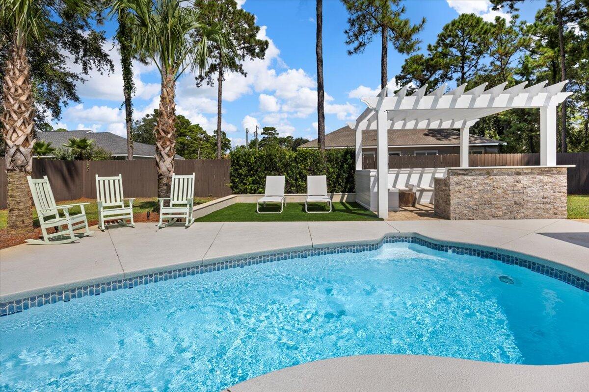 Stunning Santa Rosa Beach Home on the Emerald Coast! This beautifully updated home offers the perfect blend of coastal living. Located just a short drive to the beach, shops, hospital, and restaurants. The property features an outdoor oasis with a private pool, paved patio, outdoor kitchen, and a convenient outdoor shower. The bright and open floor plan is drenched in natural light, creating a warm and welcoming atmosphere. For those who work from home or simply need a quiet retreat, the dedicated home office offers a perfect solution. This space is well-designed with ample room for a desk, storage, and everything you need to stay productive without sacrificing comfort. Large windows provide plenty of natural light, creating an inspiring work environment. In addition to the home office, this property boasts a unique bonus feature, a detached shed currently being used as a gym. Plenty of room for your workout equipment, yoga studio, or hobby room. With a little imagination, this shed could also be transformed into a guest house, art studio, or additional office space. The options are endless! Don't miss the opportunity to make this Emerald Coast paradise your own!