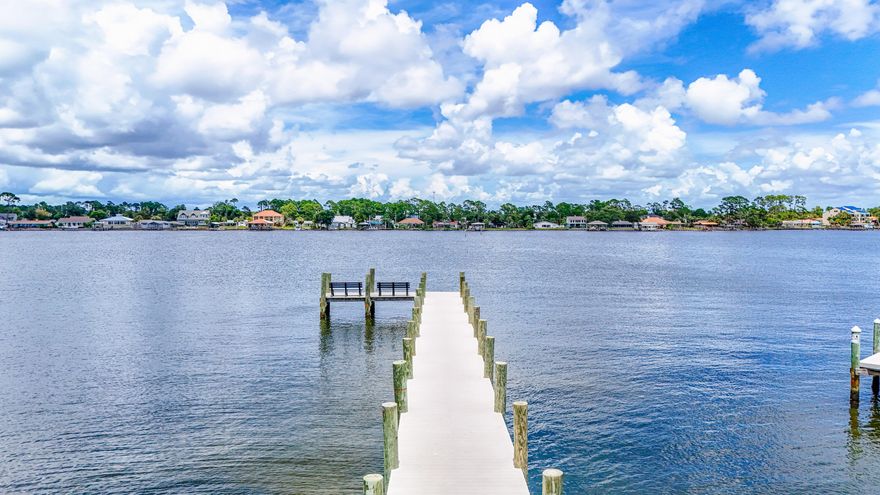 Absolutely Adorable Beach Bungalow located across from the Dolphin Boat Ramp on Grand Lagoon!!  This block home has been updated with new impact resistant windows 2019, new trusses and roof 2022, new master bathroom 2022,  new HVAC 2023, and new septic in 2019.  The outdoor living from the front porch to the backyard patio provides lots of space to gather with friends and family or just sit outside and enjoy the peace and quiet.  The Grand Lagoon is right out your front door; go fishing, paddleboarding, boating, or jet skiing. Although quaint and cozy there is plenty of room with 2 bedrooms, 2 bathrooms, open living room and kitchen, separate dining room, cozy den and reading area with lots of natural light. The workshop is a great place to store all of your beach toys, golf cart or a small vehicle.

Location is perfect!!  You can easily get to the beach, lagoon, marina and St Andrews State Park in a matter of minutes.  Enjoy great options for entertainment, dining, shopping and excursions.  This property is just a few miles from the Publix Sports Complex and Pier Park.  Yet, the neighborhood is set back for some quiet time when you're ready to relax.

