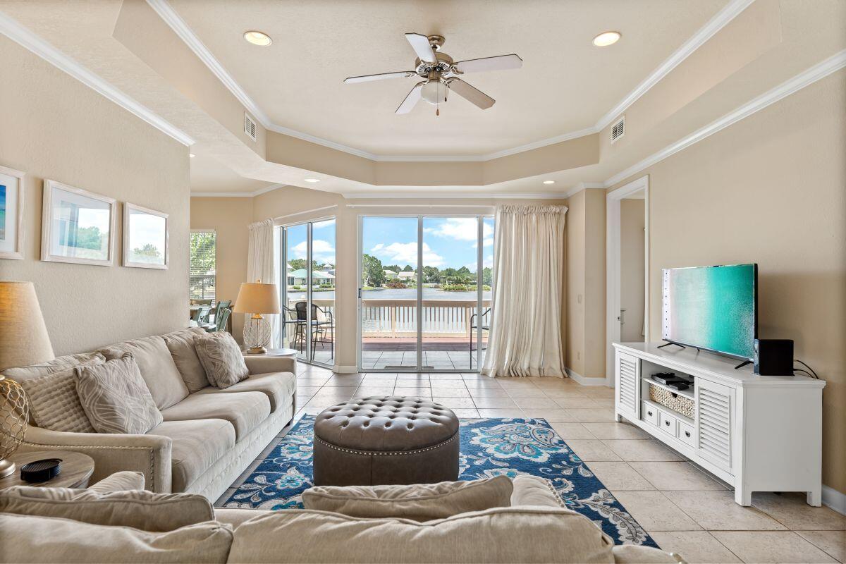 Rare opportunity to own a first-floor lakefront 3BR-3BA condo at Sandestin Resort! 2214 Crystal Cove Lane is a premier waterfront condo located in the Crystal Cove neighborhood at Sandestin Resort. The location is tucked away yet convenient to all that Sandestin has to offer. With 10 ft ceilings, this 3BR-3BA is flooded with natural sunlight and offers a spacious floor plan, a covered porch, and a sunny deck overlooking Crystal Lake. The comfy living area, updated kitchen, breakfast room, and primary bedroom all open through glass doors to the lakeside patio and deck. Both guest bedrooms offer adjoining full baths. There is a full-size laundry room, assigned parking, catch and release fishing, and access to a community swimming pool. The Sandestin beach resort amenities are available to owners.