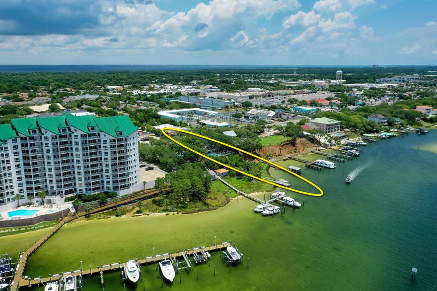 Welcome to 702 Harbor Boulevard, a legendary property graced by moss-filled, gorgeous Southern Oaks, and expanding over .50 acres on a high bluff overlooking the Scenic Harbor of Destin, Florida!
Never listed in its history, this generational home is a quintessential homestead now available for a new family to enjoy as a coastal retreat.  The home features gorgeous Heart Pine, high ceilings, separate guest cottage, and a pool with a stunning view corridor across the harbor.  This fabulous property contains 121' on the deep-water of the harbor, thus offering deep-water boat slips with the capability of mooring large vessels in the virtual wildlife sanctuary of this estate's backyard.  The infrequent offering of such a unique, charming property makes this listing extremely... special.  The location is superb, as the walkability to all the commercial establishments in the harbor district of Destin, Florida, including the world-famous Harbor Docks restaurant, which is nearly adjacent to the property, accommodate a phenomenal coastal lifestyle. The existing structures are being sold in their "as is, where is" state and condition.