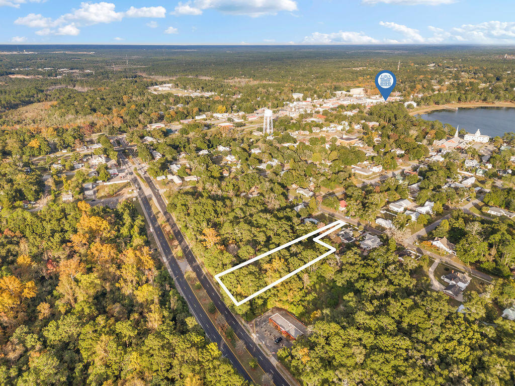 Situated on .94 acres, a prime property in the heart of the City of Defuniak Springs Historic District, offers exceptional flexibility with established infrastructure, making it ideal for residential development. The entire lot is zoned R2 low density. This allows for 4 residential units to be constructed. Utilities are right at the street and easily accessible by way of either HWY 331 or 13th Street. There is 111 feet of HWY 331 road frontage which could be rezoned to C1 for commercial use. Please contact the City of Defuniak for further details and approvals. Drainage is not an issue, as the southwest corner of the lot features a city-managed drainage intake. Not required, but pre-approved by FDOT, a vehicular bridge access from Hwy 331 to cross the small spring-fed creek, with a designated location at the northwest end of the lot. A second and preexisting 20-foot-wide driveway from 13th Street provides sufficient access for emergency vehicles and supports multi-family or business development.

Strategically located just 0.6 miles from the historic downtown and only .5 miles from Lake Defuniak makes this lot a perfect opportunity for investors and developers alike. Seller financing or contract for deed available, see listing agent for terms.