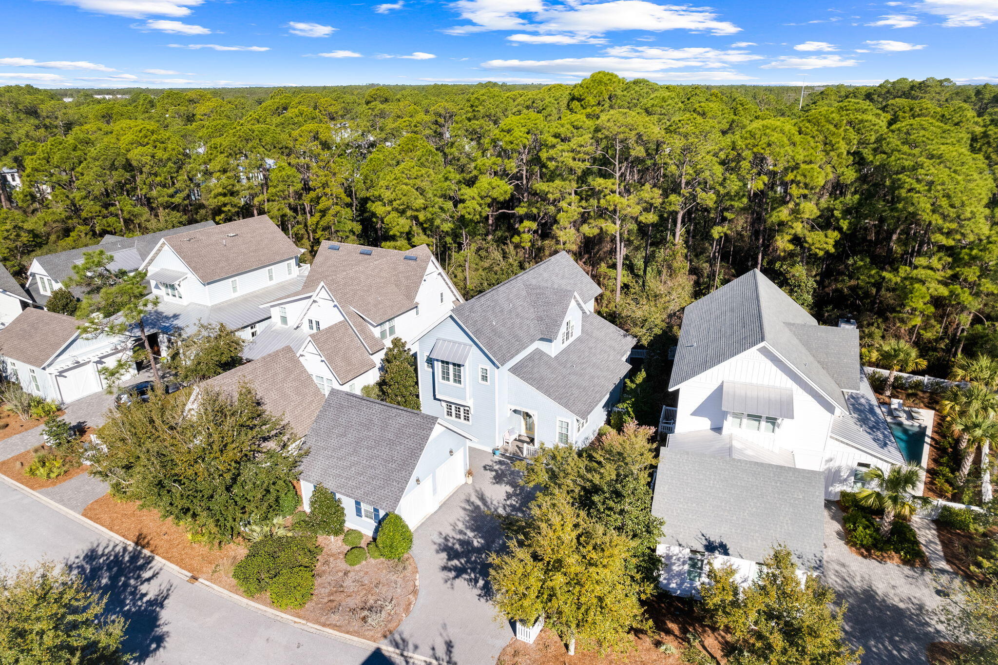 Located in an exclusive gated community,22 Sextant Lane offers premier access to the lifestyle and amenities of the Watersound West neighborhood. Backing up to the state park, this property provides an unparalleled approach to the natural resources, sugar white sands and emerald waters of 30A's coastal beaches. Siituated alongside the state park and boasting a private beach for the neighborhood residents, the access to the emerald waters is one of the most unique on 30A. The coastal design features an expansive living space that seamlessly connects the kitchen, dining area, and living room. The Chef's kitchen showcases an oversized island and luxury appliances. Step outside and an outdoor living area highlighted by a relaxing screened-in porch. The primary suite,
found on the main level, presents an extravagant bathroom adorned with a double vanity, a custom-tiled shower, complete with a walk-in closet. An office or "bunk room" alongside a full
bath and laundry room completes the main floor. Up the stairs, you will find three additional bedrooms, complete with two full baths as well as an additional sitting area. Hardwood flooring is situated throughout the house which really completes the coastal
look of the perfect beach home. Watersound West Beach is located in the highly sought after east end of 30A. Amenities include a large resort pool, walking trails and deeded beach access.