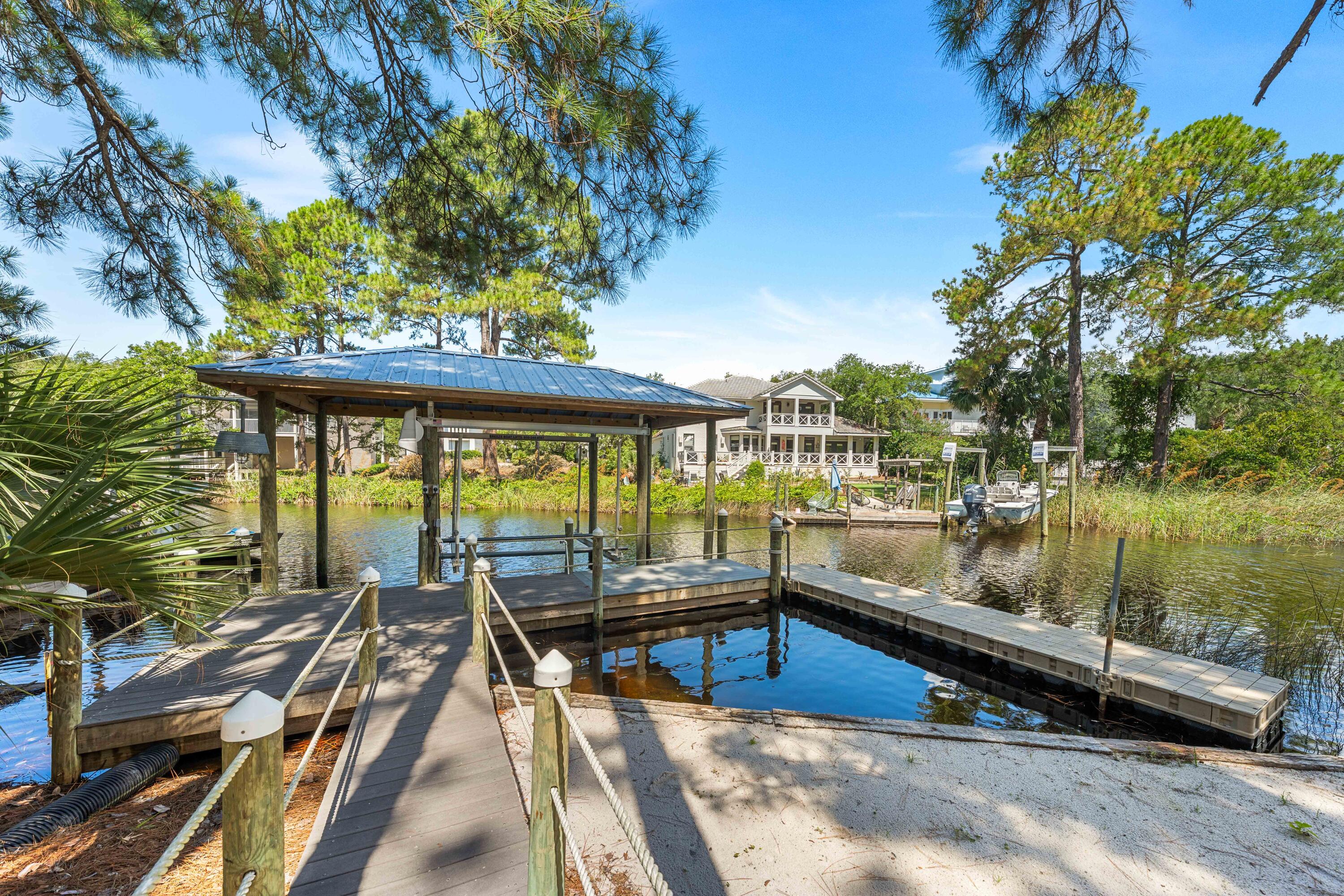 Perched on the peaceful waters of Eastern Lake with panoramic views extending to the Gulf waters, 105 Trae Lane is a true sanctuary with four bedrooms, four bathrooms, and 3,575 square feet of meticulously curated interiors. Spanning four levels featuring elevated craftsmanship, this exceptional residence was completely reimagined in 2022 and offers a rare combination of privacy, waterfront views, and modern sophistication.Inside, no detail has been overlooked. A chef's kitchen is outfitted with top-of-the-line Sub-Zero and Wolf appliances, dual dishwashers, and two ice makers--one is commercial-grade making entertaining effortless. Custom cabinetry with integrated lighting enhances every corner of the home, while other premium features add the touches of coastal creativity. creativity.
The home's layout includes multiple living spaces and an expansive screened porch, all thoughtfully oriented to maximize views and natural light. Motorized power blinds for the windows on the main level, 100% LED lighting, and two new A/C and furnace units ensure year-round comfort, while a standby natural gas generator, tankless water heater, and state-of-the-art camera and alarm system provide peace of mind.
With two washers and dryers, two climate-controlled garages with additional storage, and thoughtful touches throughout, the home is perfectly equipped for effortless everyday living or multigenerational escapes. This meticulously maintained residence has had only two owners, has never been rented, and remains in pristine condition.
Outdoors, the lifestyle continues with a private boat dock, featuring a covered 5,000-lb boat lift and floating dock ideal for launching kayaks and paddleboards directly into Eastern Lake. From there, cruise straight to the Gulf or explore the serene natural surroundings this unique lakefront location affords.