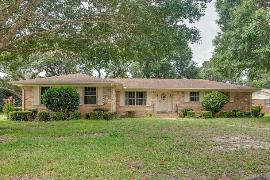 Charming! Cute and Move in Ready! This 3 bedroom 2.5 bath brick home is located on a large corner lot with old growth oaks and plants. The hardwood floors throughout have been refinished and are stunning. Two separate living areas providing a spacious feel. The kitchen is an open concept with plenty of cabinets for storage, breakfast bar and tile floor. Ready for a retro vibe? The kitchen appliances (stove and dishwasher) definitely fit the bill for a unique kitchen. The Florida room is huge! 20' x 16', heated and cooled and windows all around to enjoy the beautiful greenscape of the backyard. There is also an open patio out back. If you love garages, this two car over-sized garage has a gorgeous wooden bead board ceiling. This home was also part of the Rebuild Northwest Florida.