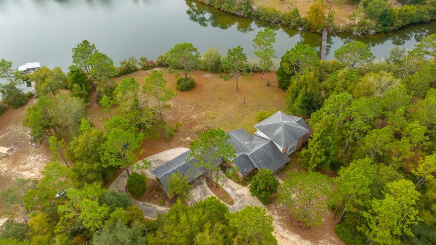 Stunning lake front estate. This 4 bedroom home has it all, the stunning views, expansive land, generous interior rooms, and quiet surroundings. As you walk in the property, you will notice the vaulted ceilings, wood flooring and open concept living space. The kitchen is spacious with breakfast bar, cabinets galore, and a HUGE pantry/laundry room area. Master bedroom is on the first floor with an additional bedroom and full bathroom. The upstairs features two bedrooms and a full bath. Additional family room, covered carport, and porch for your enjoyment!