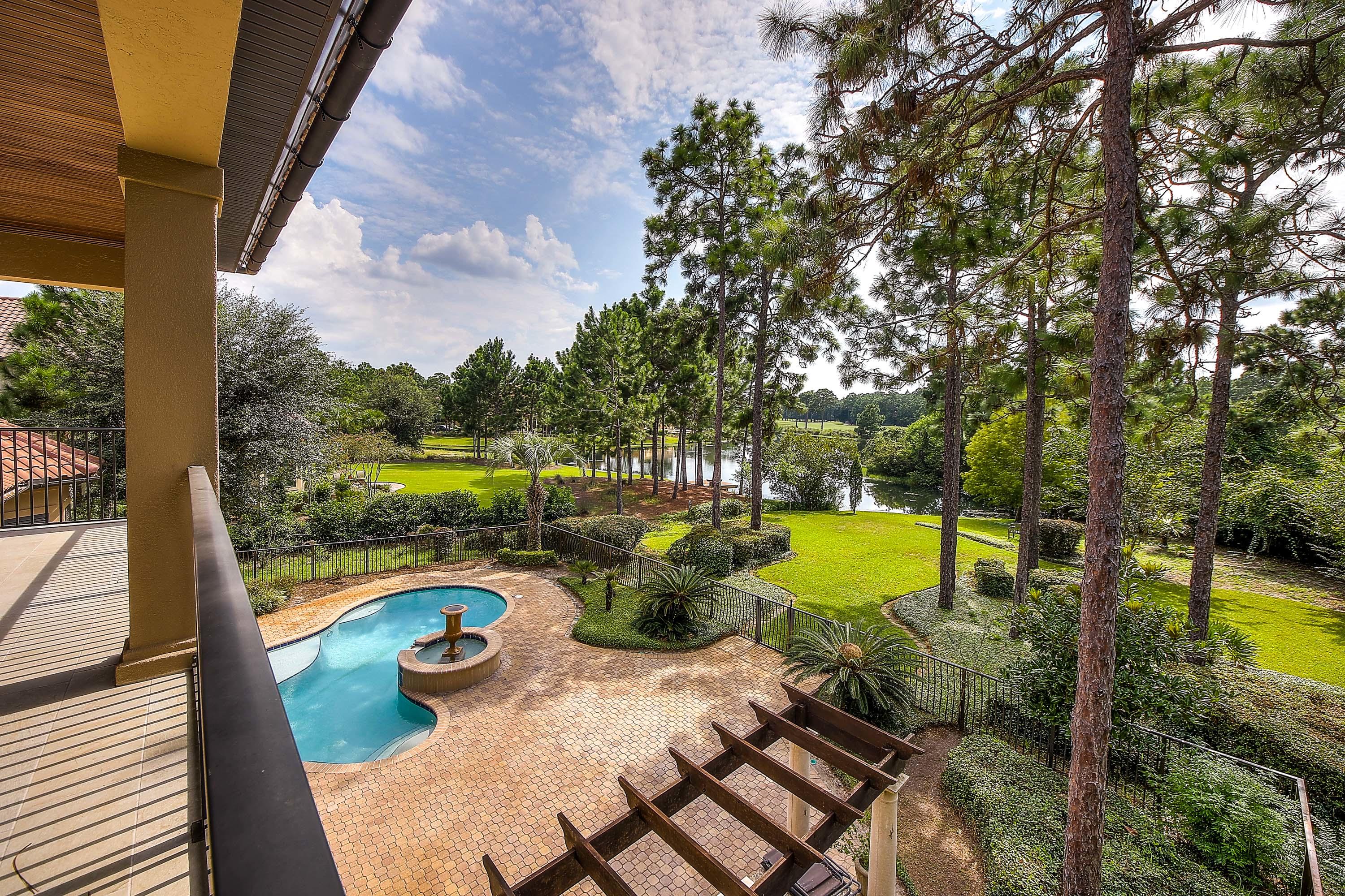 This custom home in Burnt Pine Golf Community has left nothing to be desired. It is one of the choice lots in Arrowhead Subdivision with lake views, golf course views of the #9 fairway of the Raven Golf course, and a natural area to the north side.Designed for the gourmet cook the kitchen, wet bar, breakfast nook and family room all overlook the lake and golf course and the sliding glass doors can be opened in the spring and fall for a larger entertainment area including the covered and screened lanai. The pool and water feature are just off the lanai. There is a formal living area with glass sliders, a custom study and formal dining area. The master suite encompasses the whole side of the house with