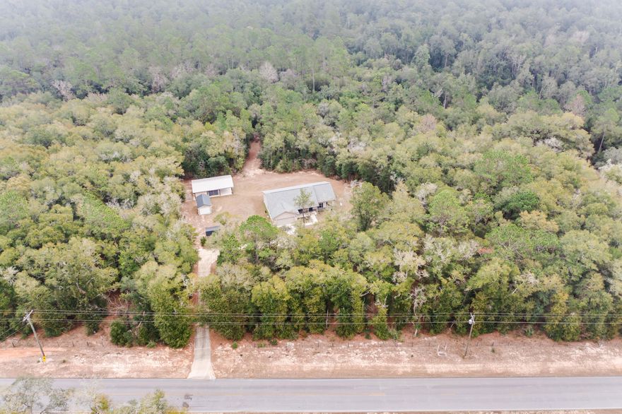 Secluded 4-acre setting featuring a custom Southern Traditional home designed with comfort and function in mind. The open floor plan offers high ceilings and great natural light, with flexible space for everyday living or entertaining. Custom cabinetry is featured in the kitchen and bathrooms, and the large laundry room includes a folding table, cabinets, and shelving. Luxury vinyl plank flooring is in the main living areas with carpeting in the bedrooms. Sellers are offering a 1-year American Home Shield home warranty (Gold level). Property improvements include a 24x36 pole barn/workshop (approx. 1/3 enclosed, 1/3 screened, 1/3 open but covered) and a 12x24 RV pad with 50-amp hookup and water. Home is occupied. Showings by appointment only. *Pictures are from when the home was built* Plenty of parking and storage with a 2-car garage, large parking pad, 14x20 portable garage, and garden shed, plus a long tree-lined concrete driveway. The rear concrete patio provides space for a hot tub and outdoor enjoyment. Partially fenced acreage backs to undeveloped wooded land. Convenient to major commuting routes and nearby area bases. Buyer to verify all information deemed important, including measurements and acreage.
Professional pictures are being done on 1/9/2026.
*Security cameras and/or recording devices are present and in use both inside and outside the home. Visitors acknowledge possible audio/video recording white on the property.*