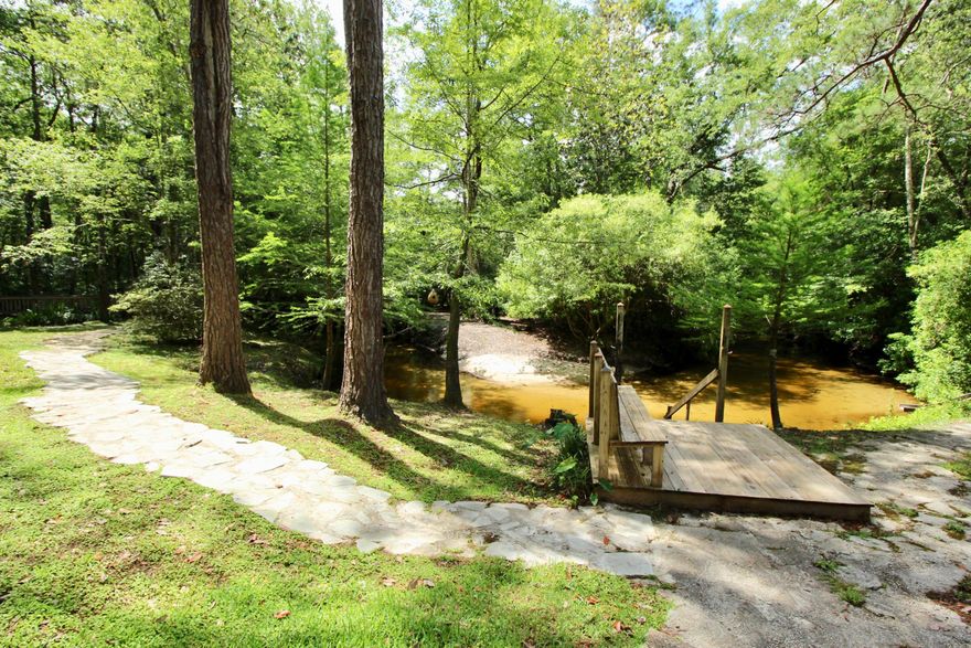 Dreamy 10 acre Alaqua Creek estate abutting Eglin Reservation for ultimate peace & privacy. Two beautiful homes - perfect for multiple families/generations. Would make a fabulous vacation rental that could double as a corporate retreat. Situated on winding sandy bottom Alaqua Creek, both homes have stunning views. Main home has cascading decks, perfectly lit for nighttime enjoyment, with stairs leading down into the clear, crisp water. Even a slide for the kids (or maybe adults)! Main home is 3049sf with 3 beds/2.5 baths (3615sf of wrap around porches alone) built in 1994 & updated in 2008. Marvelous fully equipped outdoor kitchen. Second home is 1600sf with 2 beds/1.5 baths (appx 1600sf of wrap around porches) built in 2005. This is truly a one of a kind retreat! See pics for details!