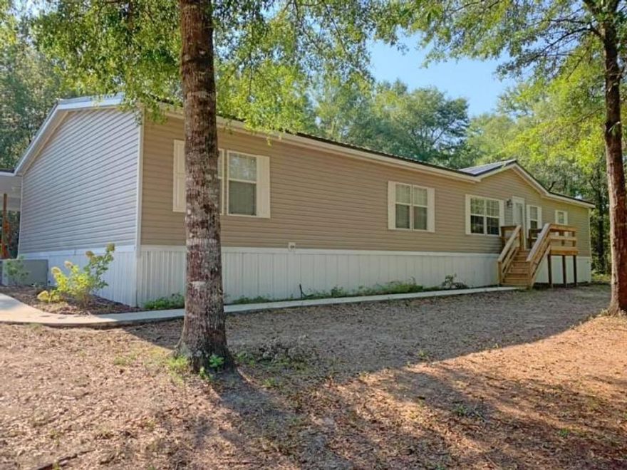 SPACIOUS!!! Fully renovated move-in ready 2280 sq ft manufactured home with 4 bedrooms & 2 bathrooms situated on 10 acres. The open floor plan makes it easy to navigate with the living room, family room & kitchen being connected by the dining room. The over sized master bedroom with 2 ceiling fans gives you plenty of room to have king sized furniture & a sitting room area. The split bedroom floor plan puts the other three bedrooms, additional bathroom & utility room on the other side of the home. The renovations include a new roof (2018), carpet, higher end laminate flooring, appliances, fresh paint, lighting fixtures, ceiling fans (7), new front and back door, baseboards. crown moulding, front & back deck and 30x24 two car carport that has a brand new concrete pad and the list goes on This home was under contract for 75 days. The Buyers financing fell threw at no fault of the Seller. This home has had a home inspection preformed with limited repairs need and repairs have been done.
