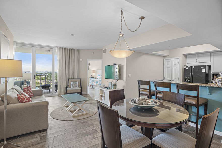 Breathtaking panoramic views of the Gulf of Mexico and the Destin skyline plus $8k in future bookings!   Enjoy countless days on the patio watching boats in the Gulf or witnessing the stunning Destin sunsets. The condo boasts two spacious bedrooms with king beds and both offer balcony access, making it ideal for use as a second home, vacation rental, or primary residence. Located on the 10th floor, this fully furnished 2-bedroom unit offers a carefree beach lifestyle, with ALL utilities included in the HOA dues, including electricity. There are numerous upgrades to enjoy, such as beautiful flooring throughout, HVAC 2022, coastal colors and decor, smart TVs in the living room/bedrooms, and a stackable washer and dryer. The resort amenities are impressive and include tropical landscaping, an 11,000 sq ft lagoon pool, a heated pool, a children's kiddie pool area and splash pad, tennis, pickleball, basketball, an onsite restaurant, a tiki bar, and a coffee shop, a fitness center, a covered parking area, and security. Electric vehicle charging stations also available. Additionally, a free beach shuttle runs seasonally to take you across the street to the beach or to Harbor Walk for shopping and dining.