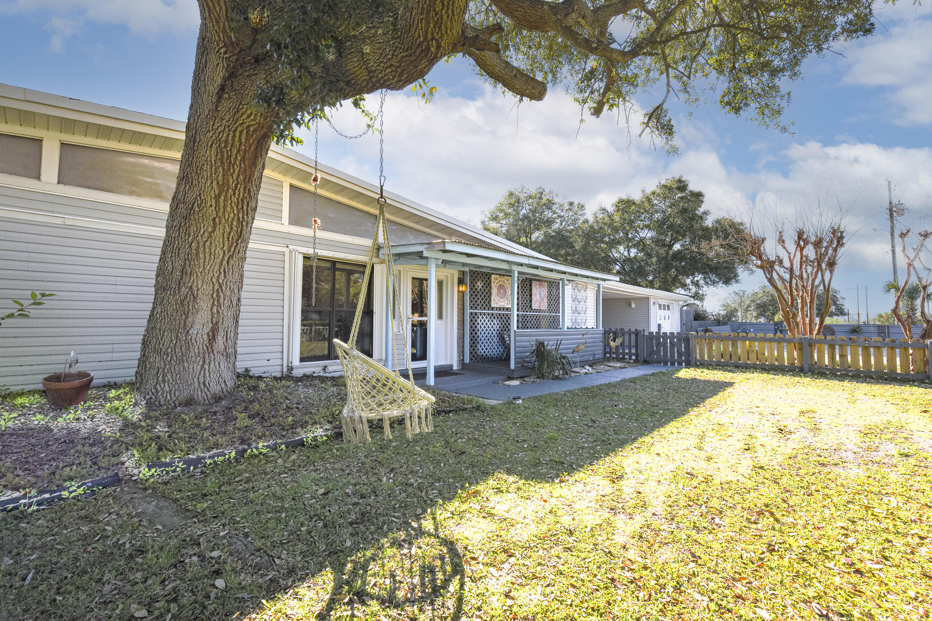MULTI-GENERATIONAL HOME located in Fort Walton Beach, FL. Endless possibilities with this large 3 bedroom home with a mother in law suite and 2 lock out opportunities. This property would be perfect for a large family or someone looking for 3 mother-in-law suites. You will love the communal backyard that shares a large pool and outdoor space that can host considerable sized gatherings. This home is made for entertainment as there is plenty of space for everyone. The main home offers a sunken living room, a formal dining and informal dining space that overlooks the living room. The kitchen is open to an informal dining space and is equipped with a gas range.Just off the kitchen you will find a generous sized laundry room (indoor) a bathroom and a good-sized suite The covered side porch off the main home is the perfect place for some privacy. The porch is just off the formal dining room which makes easy access to the kitchen and living room; It's the perfect spot for your morning coffee or afternoon cocktails.
Studio #1 is connected to the main home but could be a lock out if needed. It conveys as seen with a queen bed, a full bath, and a small dining area. This mini suite has its own private entrance and has access to the communal backyard and pool.
Studio #2 is true lockout complete with a queen bed and a kitchenette.
The communal backyard is the heart of the property featuring a large pool, grilling area, outdoor dining, poolside bar- what a great place to impress your guests!
The current owner has security cameras set up as an extra layer of peace of mind.