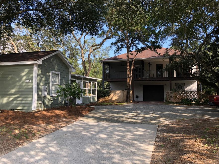 Price includes two houses! This Calhoun Compound is for sale partial water view. Features include a separate guest house and another separate efficiency with its own entrance and 3/4 kitchen. This custom home has so many options they cannot all be explained or captured in pictures. If you are remotely interested you really must see it in person.  The garage has 12 foot ceilings with over 1600 sq ft all professionally epoxy flooring. Could fit a boat, RV, car collection or whatever your imagination can think of. Both houses have been updated. Real wood floors, granite in kitchen and baths, travertine in both baths, gas cook top, wall/microwave oven combo, huge balcony partially screen with a large deck downstairs, Open floor plan  with 11 foot ceilings with high end crown molding throughout