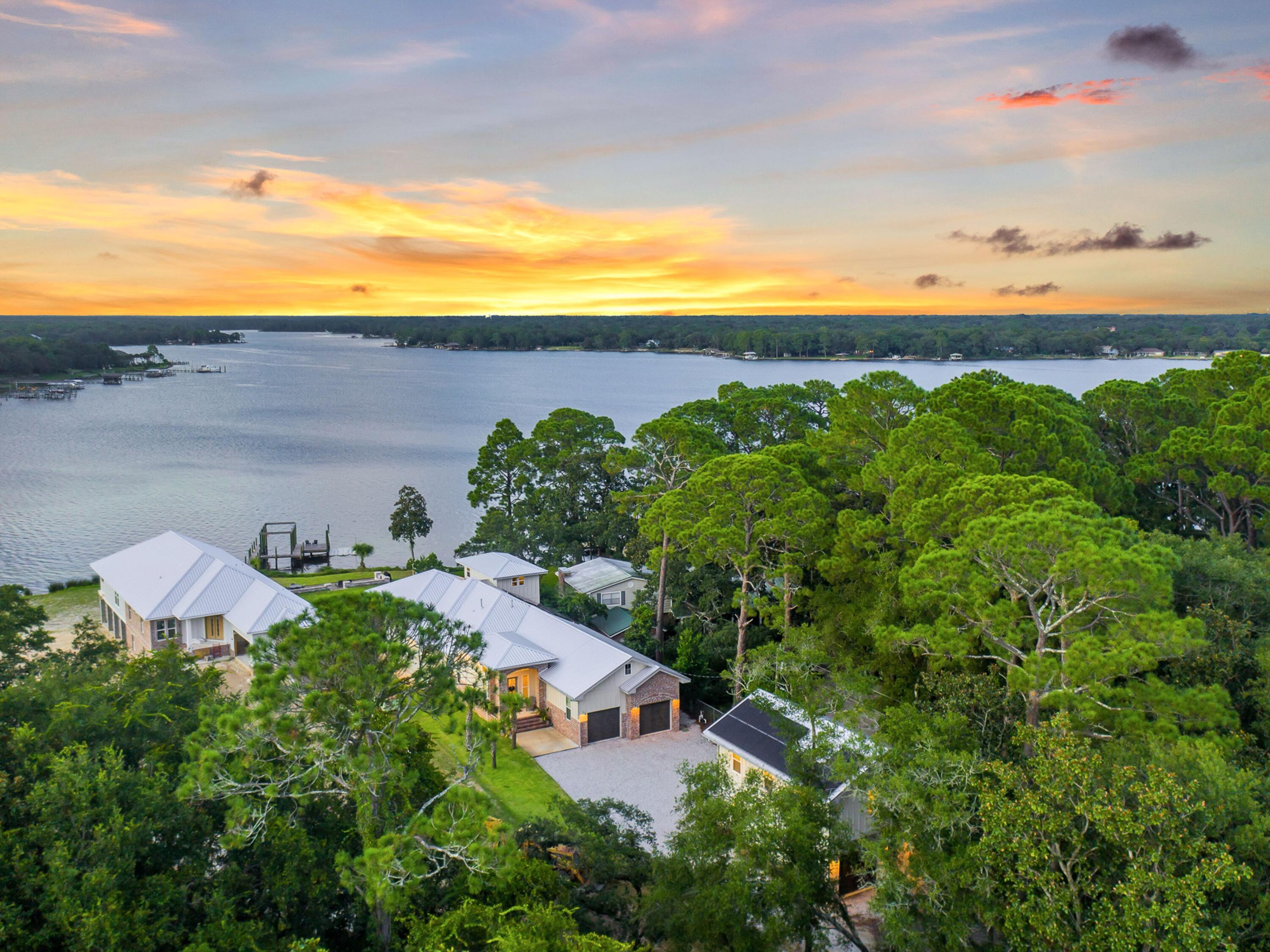 New construction opportunities are a rarity on the water in Fort Walton Beach and this nearly-new farmhouse-style build on 81 feet on Garnier Bayou is a must-see. Completed in 2020 as a builder's personal home, the 3,252-sq.-ft. main residence sits on more than a half-acre lot and features three bedrooms and two-and-a-half baths. A two-bedroom carriage house, dubbed the 'Beach Barn,' offers an additional 748 square feet of living space perfect for visiting family or guests. Inside the main home, delight in the open waterfront living on the first floor that seamlessly blends the living, dining and kitchen areas with wet bar to the spacious 40-by-15 patio that fronts the water. A second-floor pilothouse makes an ideal den or could be converted to a fourth bedroom.