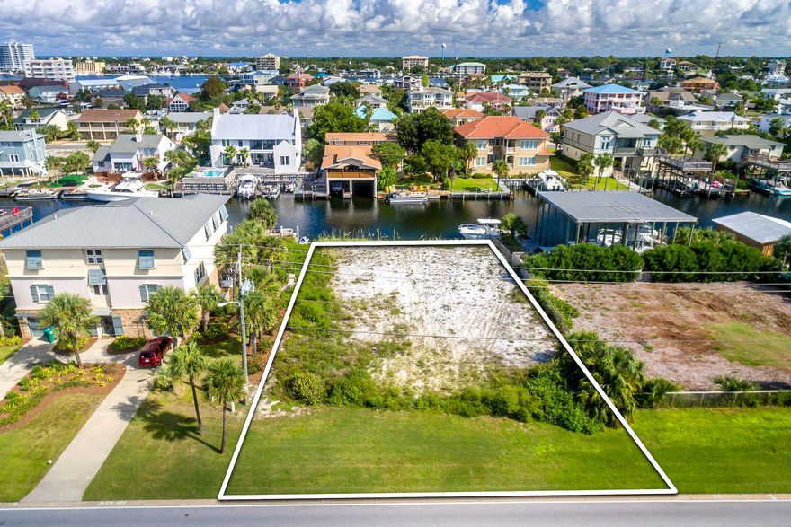 Large canal-front lot with 90 ft of deep water frontage on acclaimed Holiday Isle. This homesite offers the convenience and amenities of Holiday Isle plus Gulf views and beach access just across the street. Holiday Isle is a 2-mile long peninsula renowned for its beautiful beaches, fishing, and boating, and eclectic homes.