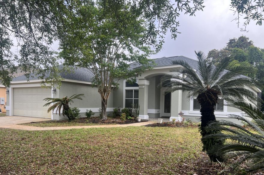 Dream home with pool and low HOA fees. Manicured neighborhood. Recently updated and move-in ready. This gem is a MUST SEE! New roof installed in 2024, freshly painted elastomeric exterior.  Nestled in the heart of Destin, this home boasts proximity to all amenities. Indian Lake provides a serene backdrop, with added privacy from a natural buffer zone in the backyard. Step inside to an inviting atmosphere of openness, accentuated by high ceilings and an open floor plan. Cozy up by the gas fireplace in the living area, while tray ceilings adorned with crown molding add elegance to the dining room and master bedroom. Retreat to the spacious master suite, complete with a dual vanity, garden tub, separate shower, and a generously sized walk-in closet.