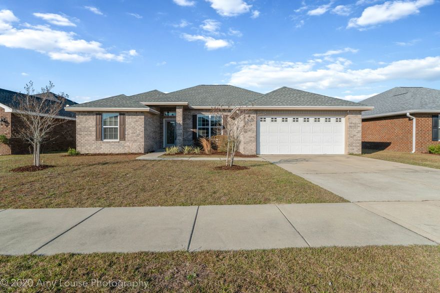 Welcome to this newer 4 bedroom POOL home located in a central neighborhood with sidewalks. This all brick home has a new roof, fresh paint, tall ceilings, wood flooring and wonderful finishes throughout! The home features a split floor plan with two bedrooms towards the front of the home, a 3rd additional bedroom tucked in the back of the home. On the other side of the kitchen is the master bedroom with new carpet and gorgeous master bathroom!The kitchen and open living area enjoys beautiful views of the private backyard with gunite pool. The kitchen has stainless steel appliances, white cabinets, granite counters and updated lighting. The living room has fabulous wood flooring, detailed trim work and neutral paint.