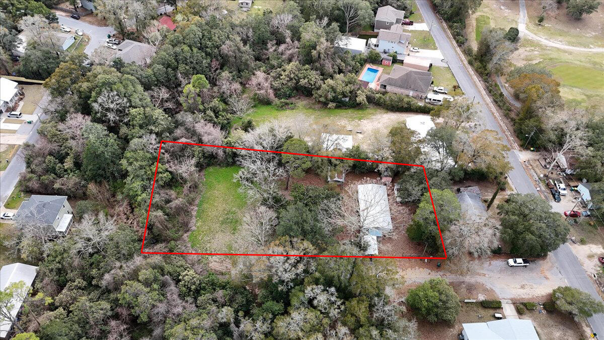 This oversized .88-acre property is a rare find in a quiet Niceville neighborhood. It includes two parcels and a livable 1997 double-wide (3 beds, 2 baths, 2 sitting rooms), with utilities and septic already in place. Looking to build? With City approval, this could be split into multiple buildable lots. Plus, no flood zone, no HOA, and no restrictions--just land, opportunity, and options! Located minutes from Eglin AFB, Hurlburt Field, and Duke Field, and just 15 minutes from the world-famous white sand beaches of the Emerald Coast!
