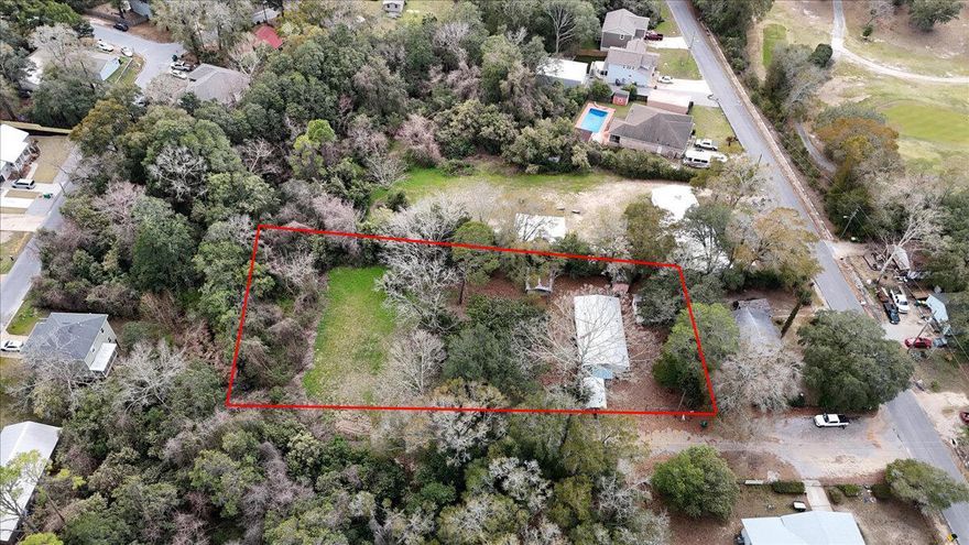 This oversized .88-acre property is a rare find in a quiet Niceville neighborhood. It includes two parcels and a livable 1997 double-wide (3 beds, 2 baths, 2 sitting rooms), with utilities and septic already in place. Looking to build? With City approval, this could be split into multiple buildable lots. Plus, no flood zone, no HOA, and no restrictions--just land, opportunity, and options! Located minutes from Eglin AFB, Hurlburt Field, and Duke Field, and just 15 minutes from the world-famous white sand beaches of the Emerald Coast!