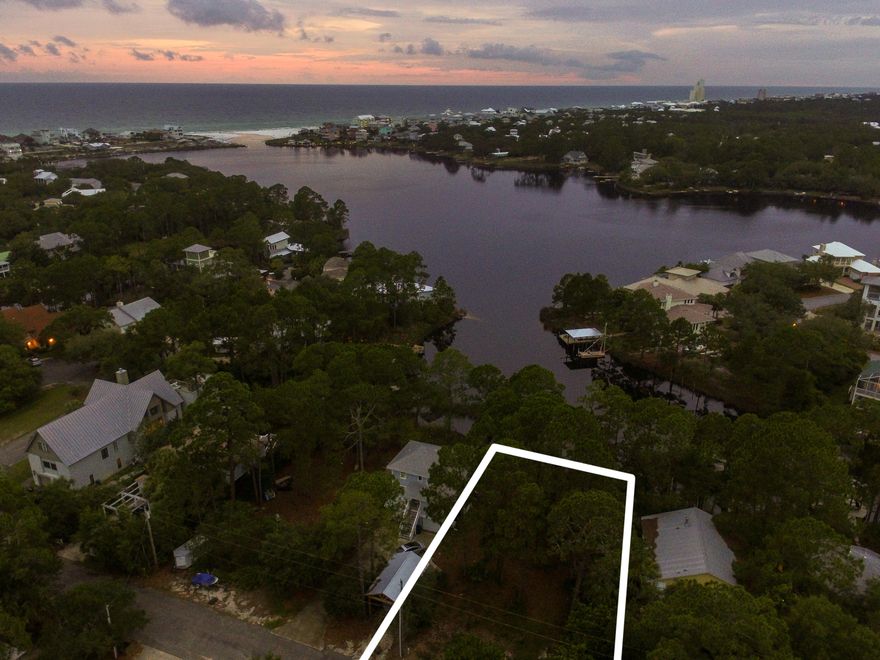 Welcome to Trae Lane, a quiet, intimate neighborhood that beckons with a tree-lined street and stunning waterfront views. This lightly wooded parcel offers you the exquisite opportunity to create your residential masterpiece, gracefully overlooking Eastern Lake, one of our area's rare Coastal Dune Lakes. Endless possibilities abound as your imagination allows, with potential Gulf views from the second or third floors of your future residence. Enjoy the peace and tranquility of nature and your surroundings on this private lot, with no build-out time frame. Be close to everything and worlds away in your own private sanctuary on this pristine parcel, truly offering the best of all worlds.