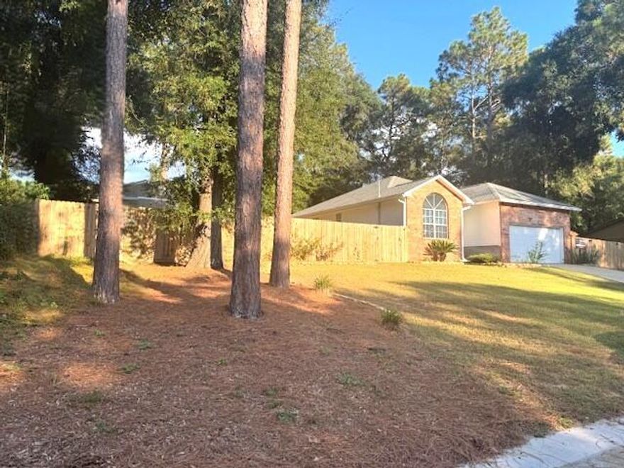 Move-in ready home, conveniently located in northwest Crestview, close to both Hwy 90 and Hwy 85. New roof! 2022) New water heater! (2024) New HVAC! (2019) Freshly painted and new carpet throughout the home, with new tile planks in the dining area and kitchen. Even the electric switches and hardware have been updated. You'll love the new fully fenced property with an interiior fence for your convenience. The right side-yard has racks for storing kayaks and a double gate for easy placement of your boat or RV. The left side-yard has a pad in place for an above ground pool, a storage shed, and even a small garden area.  Did I mention no HOA? This one won't last long! What are you waiting for?