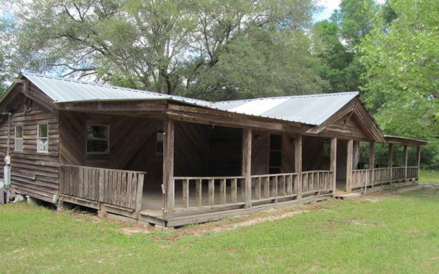 REO. This is what country living looks like! This 2 bedroom cabin is located on just over 8 acres in Holmes county. Bring your rocking chairs for this huge front porch! Home features a fireplace in the living room, spacious dining room, and a bonus room located off of the kitchen. Both bedrooms are located on the opposite side of the home. Home needs TLC. Will not qualify for any financing. Cash transactions only. Call today to schedule your tour. Property sold ''as-is.''