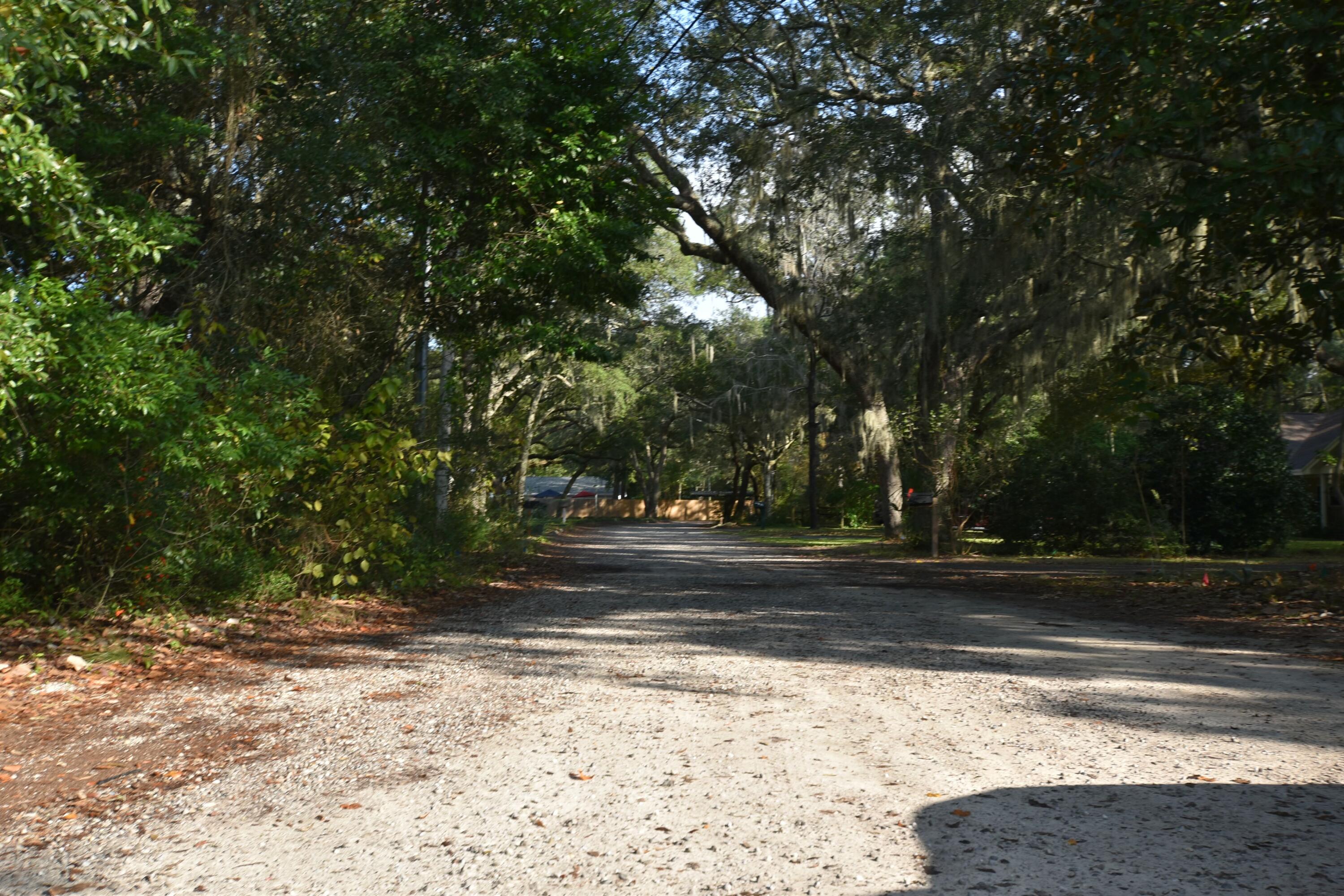 This serene lot, shaded by majestic oak trees, is nestled against a waterfront property with limited bay views between the trees making it an ideal location for those seeking tranquility and natural beauty. Valparaiso's small-town appeal, friendly community, and proximity to Eglin Air Force Base add to the property's allure, while its convenient access to schools, shopping, dining, and outdoor activities ensures a perfect blend of peaceful living and accessibility.